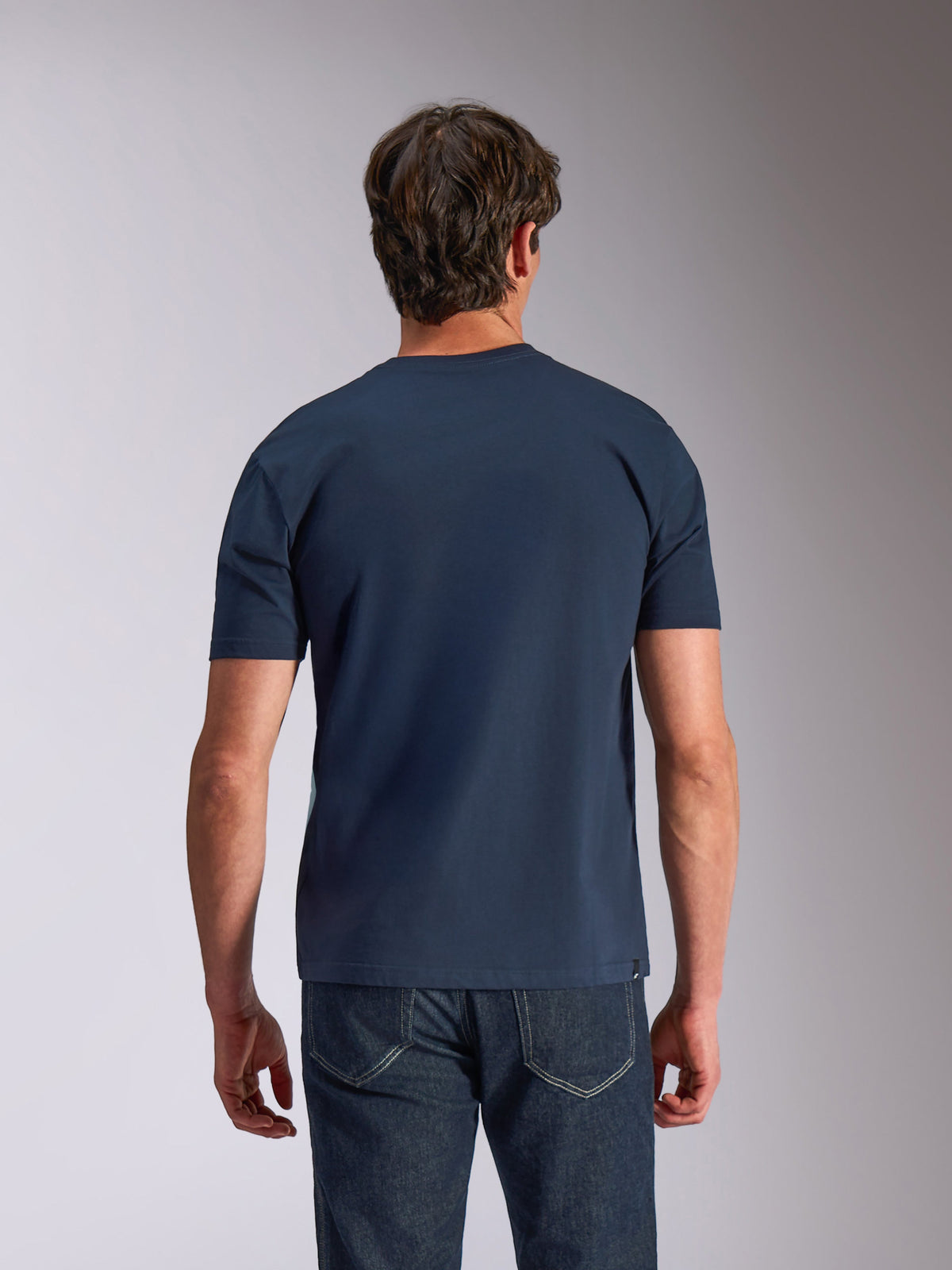 Alpinestars Ageless Shadow CSF Tee, T-shirt met korte mouwen, marineblauw, achteraanzicht, gedragen door model met donkere denim, casual motorsport lifestyle-kleding