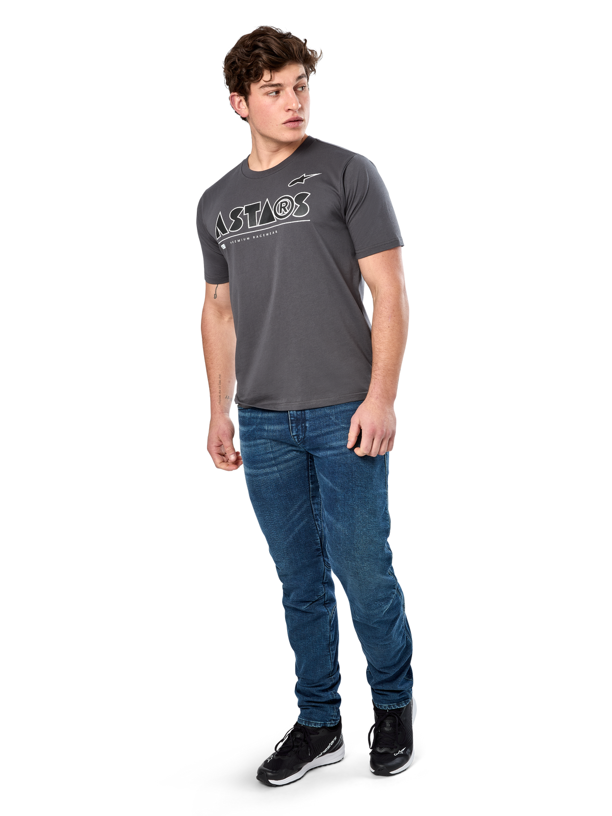 Alpinestars Cereal CSF Tee, T-shirt met korte mouwen, charcoal, wit geometrisch Astars-tekstlogo, casual motorsport-streetwear gedragen met blauwe jeans en zwarte sneakers