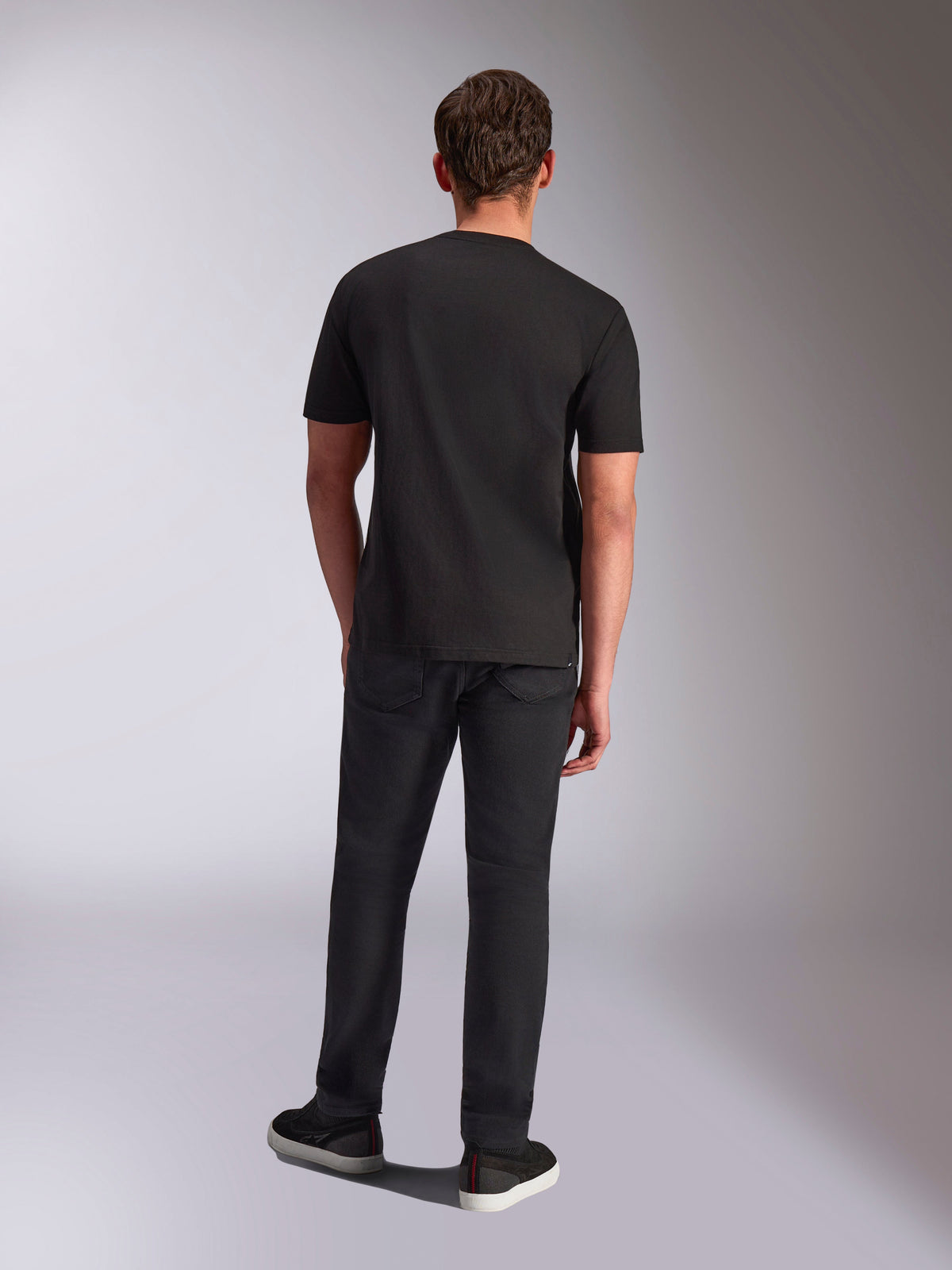 Alpinestars Trifecta CSF Tee, Short Sleeve T-Shirt, Black, back view on male model, worn with black pants and black sneakers, casual motorsport-inspired streetwear