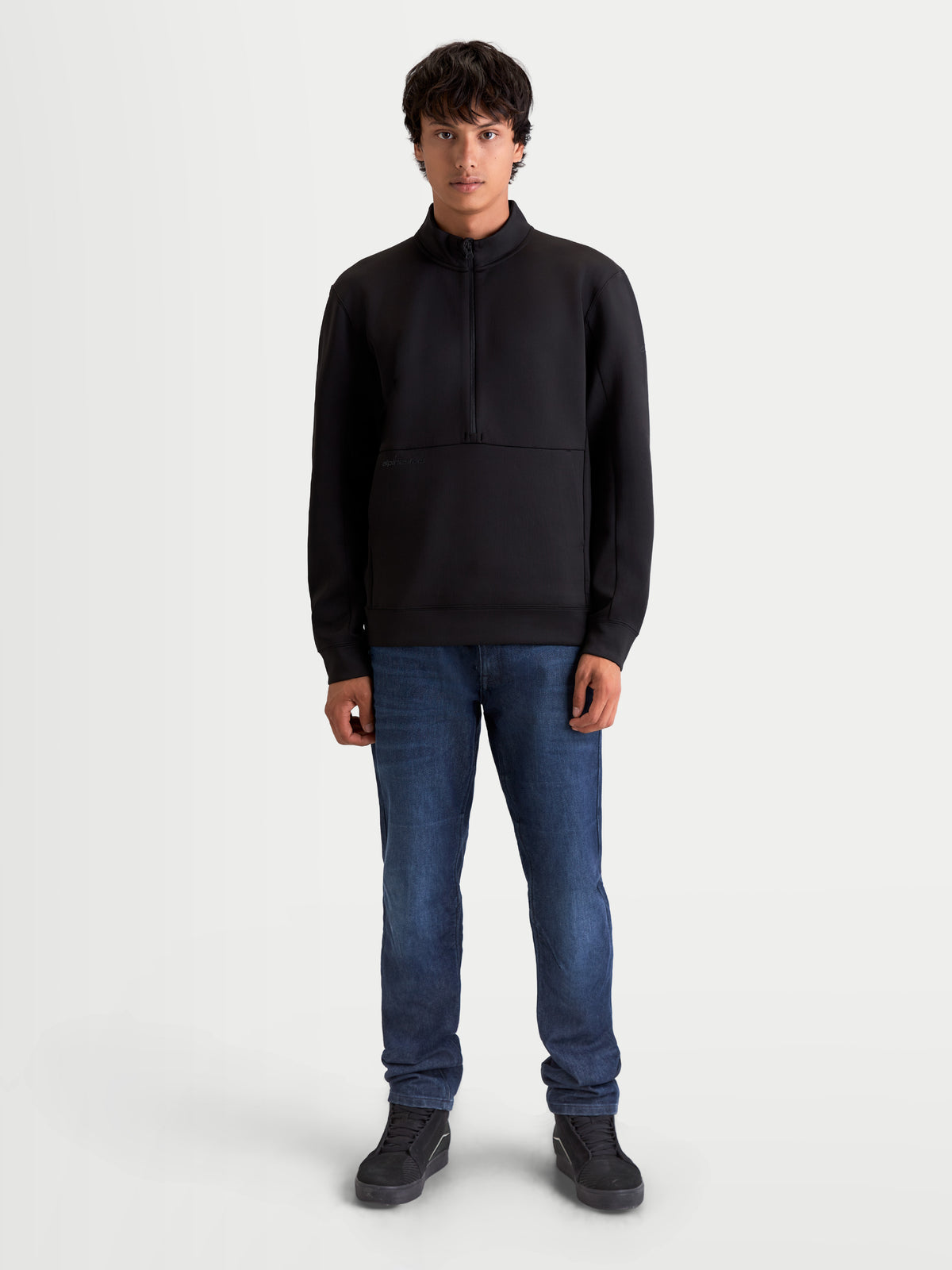 Alpinestars Apera Half-Zip Sweatshirt, Men's Sportswear Pullover in Black, featuring a half-zip closure and kangaroo pocket. Premium tri-blend fleece construction with motorsport-inspired styling and tonal Alpinestars branding for casual everyday comfort.