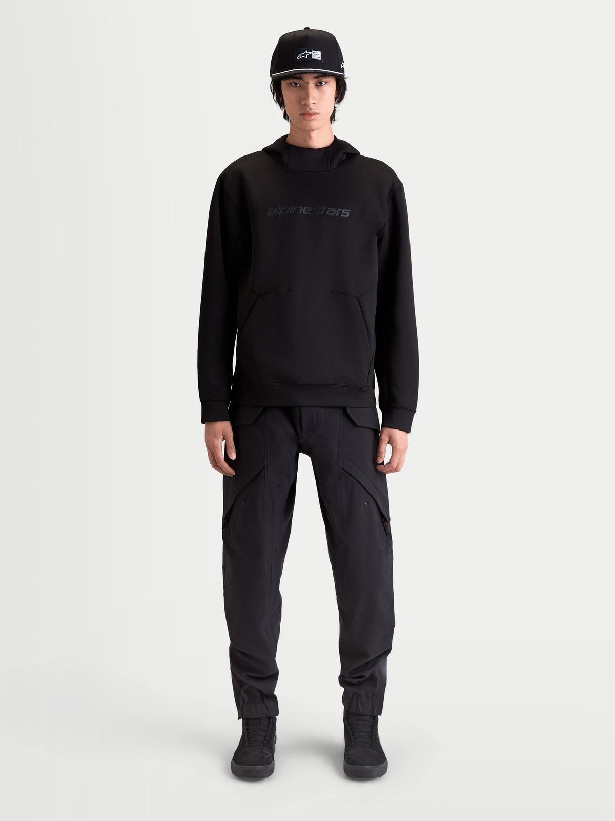 Alpinestars Datrix Hoodie, Men's Premium Sportswear Pullover, Black, featuring tonal HD Alpinestars branding, tri-blend double-face fleece, and dart-detail pocket, shown on model for everyday motorsport-inspired style.