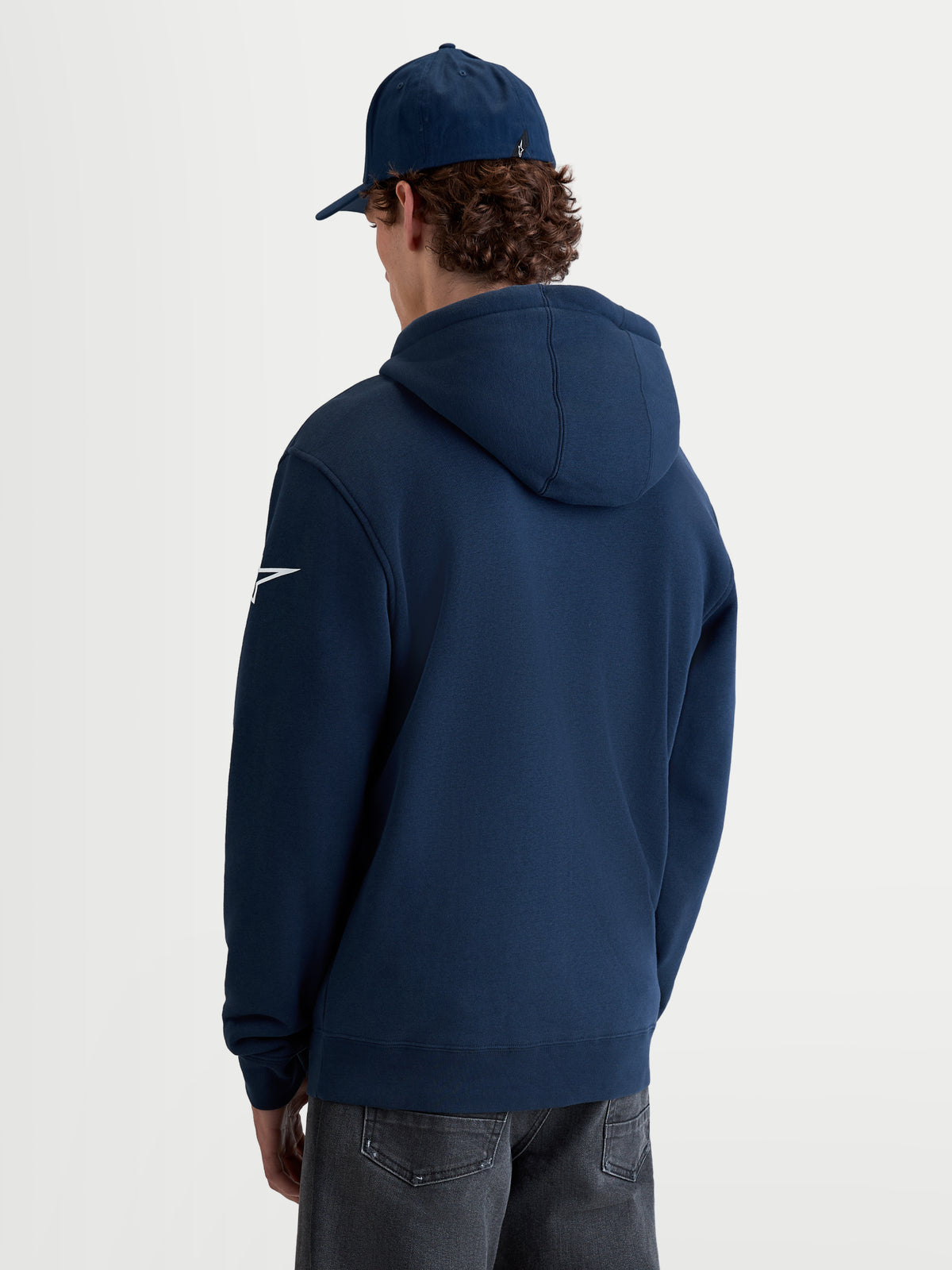 Alpinestars Race Wordmark hoodie, heren sportswear pullover fleece, navyblauw en wit, achterzijde op model met wit Ageless-logo op de mouw en gevoerde capuchon.