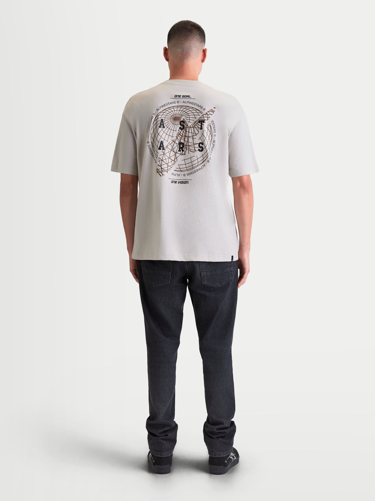 Alpinestars Latitude Oversized CSF Tee, Men's Short Sleeve Sportswear T-shirt in Cement Gray, rear view on model showing large globe and wordmark graphics on the back, relaxed oversized fit.