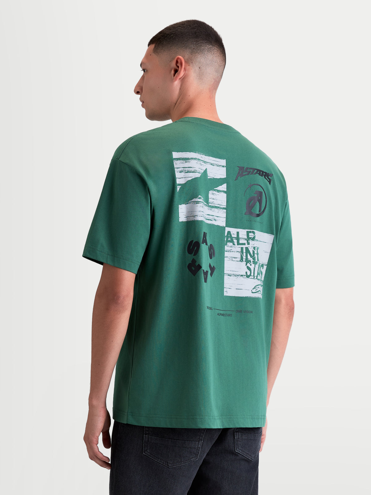 Alpinestars Checkback Oversized CSF T-Shirt, groen sportswear t-shirt voor heren en dames, achteraanzicht op model met een opvallende witte en zwarte checkergraphic, Astars-logo en motorsport-branding, casual oversized fit.