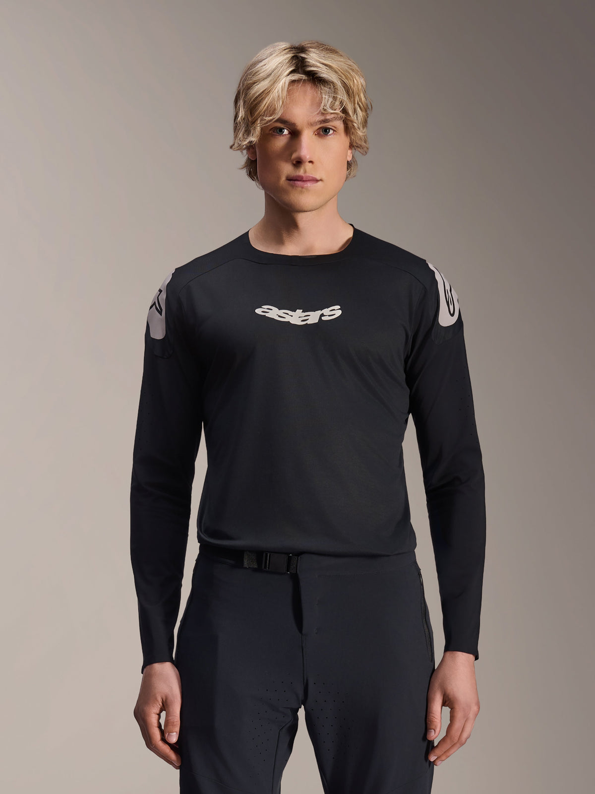 Alpinestars A-Aria Polartec Elite Jersey, Long Sleeve MTB Jersey, Black, featuring white 'astars' chest logo and white shoulder graphics, performance cycling gear worn by a model