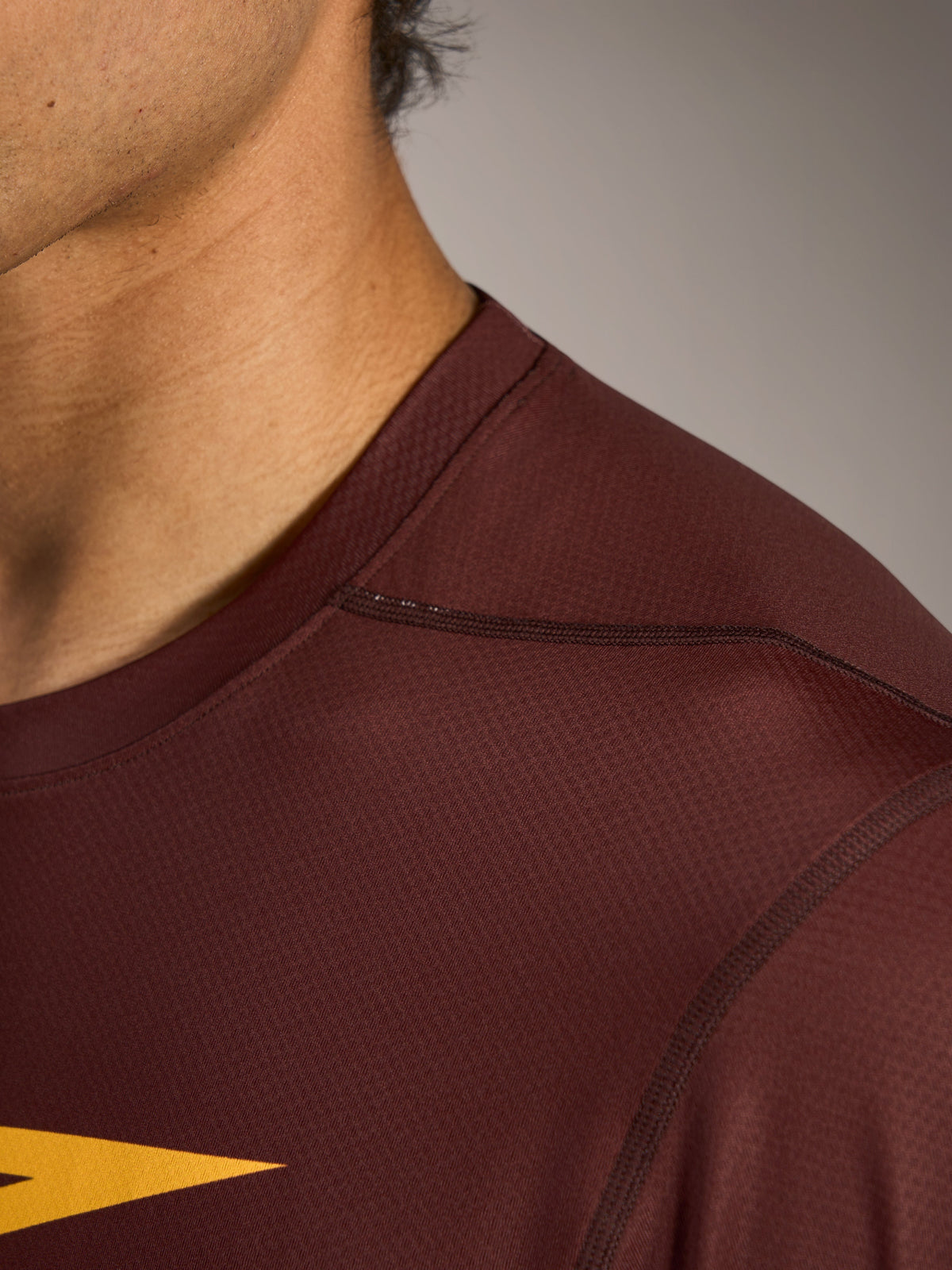 A-Dura Ride Long Sleeve Jersey in Bordeaux, showing the textured jacquard fabric and ergonomic shoulder seam construction.