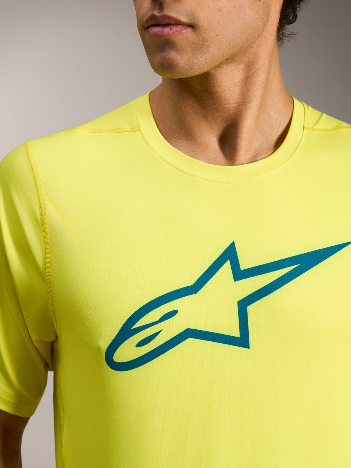 Yellow Fluo A-Dura Ride Jersey met korte mouwen en teal Astars-logo, lichtgewicht technische MTB-kleding.