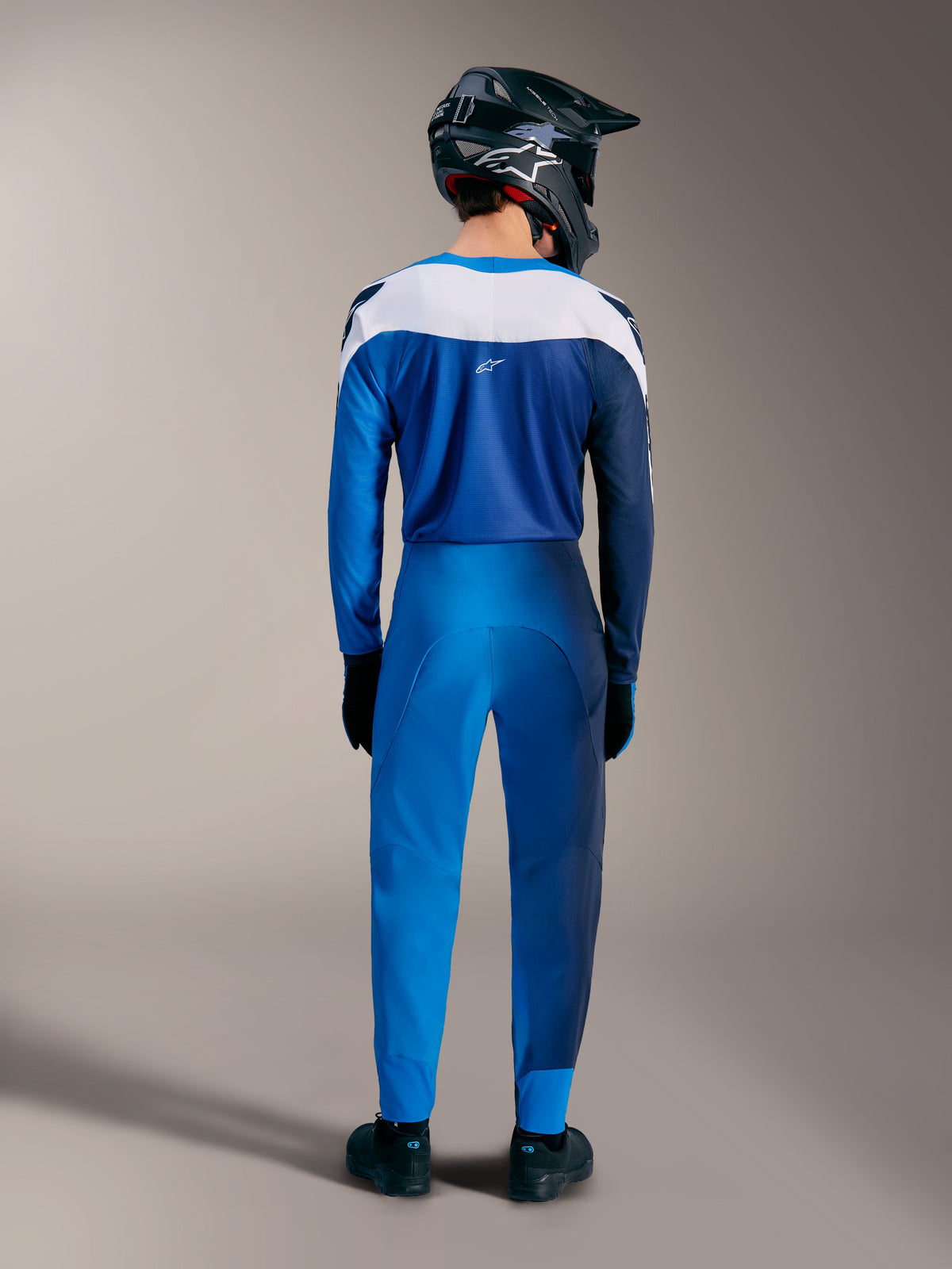 A-Supra Elite MTB-kit in Faded Bright Blue, achteraanzicht van de jersey met kleurverloop en broek met witte panelen.