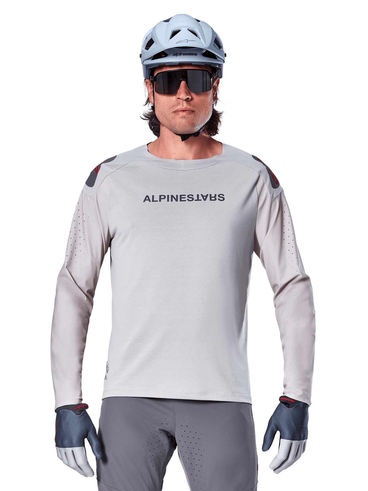 Alpinestars A-Aria Polartec Switch Long Sleeve Jersey, Light Gray mountain bike jersey featuring laser perforations on sleeves and chest branding, worn with light blue helmet, sunglasses, and gray gloves