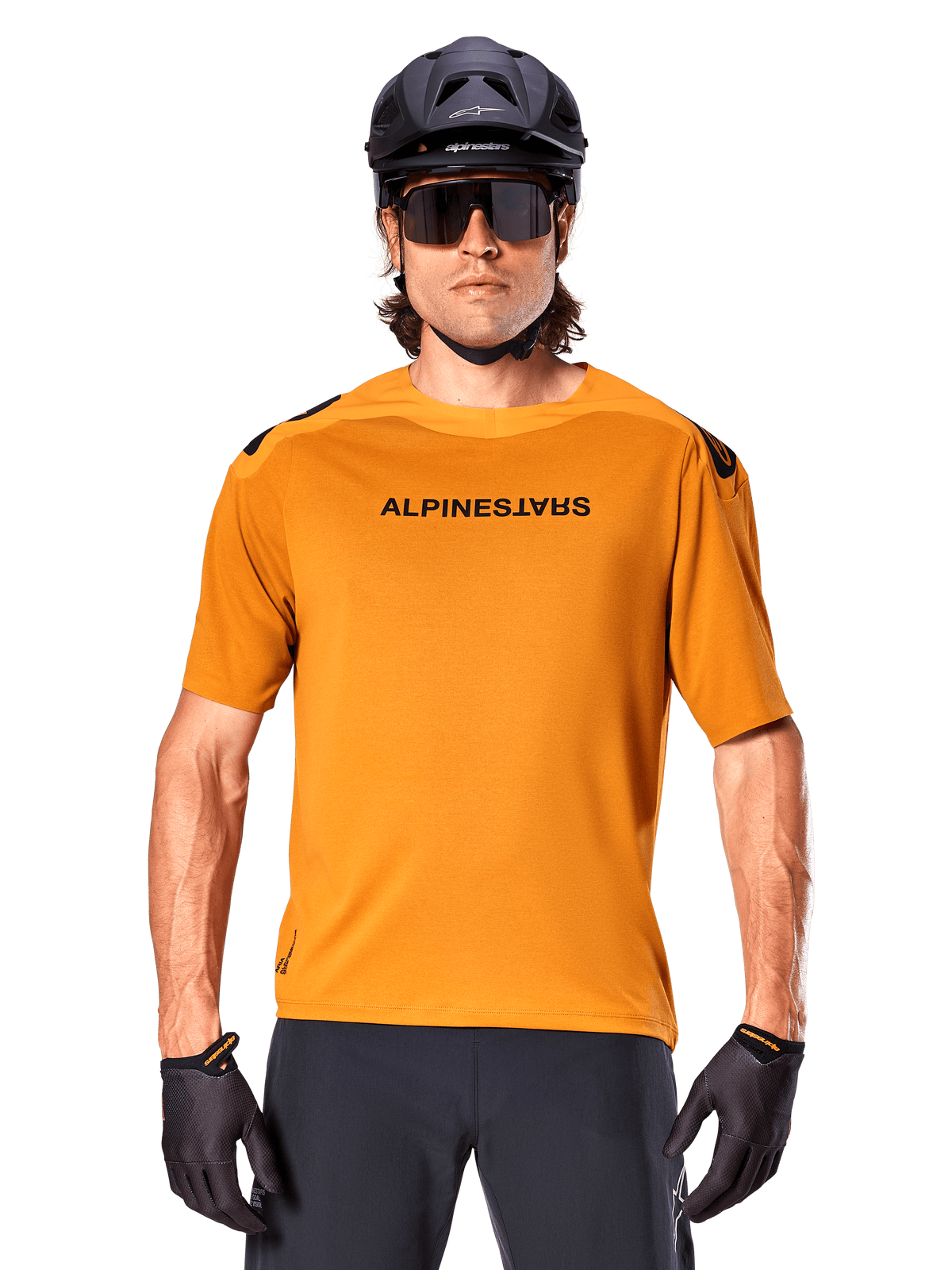 Alpinestars A-Aria Polartec Switch Jersey - Short Sleeve, Dark Gold, mountain bike rider wearing black helmet and sunglasses, performance cycling apparel for MTB trails
