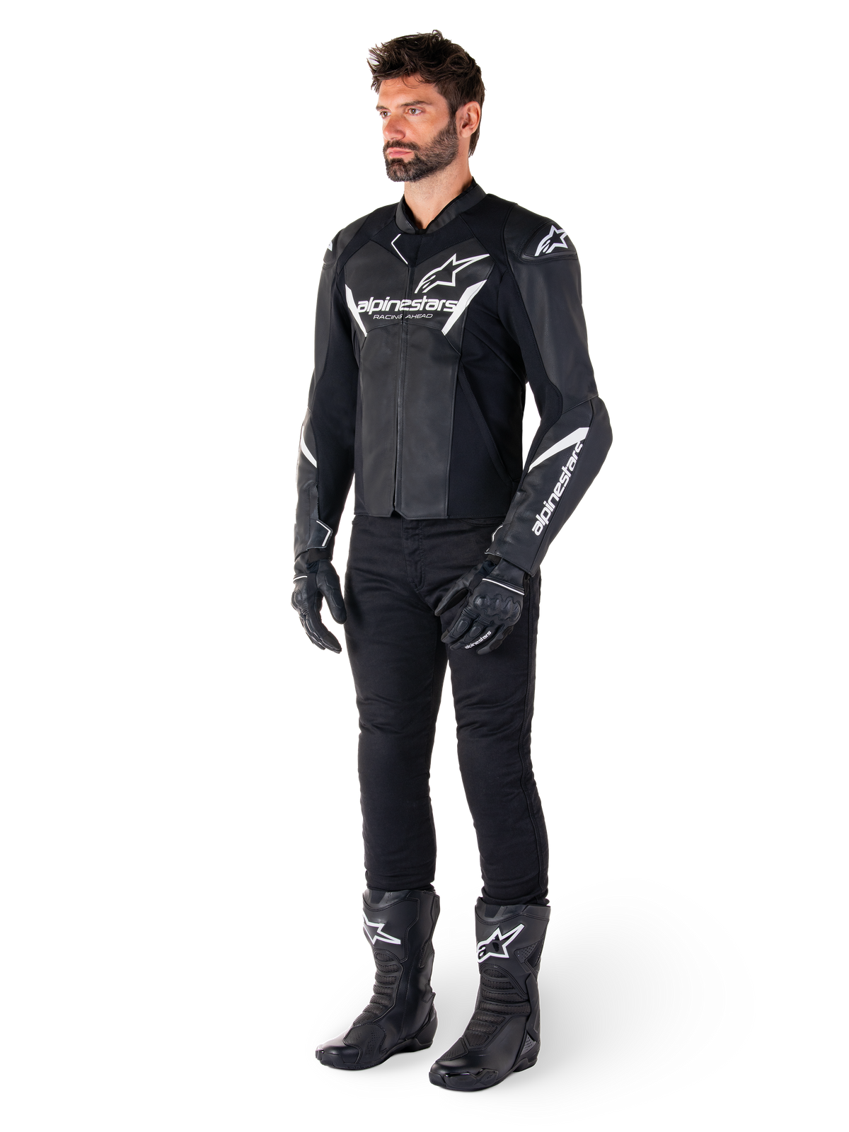 Male model wearing Alpinestars Faster V3 Leather Jacket, Sport Riding Jacket, Black and White, paired with black motorcycle pants, gloves, and boots, featuring white branding and logos, sport-fit silhouette for road racing