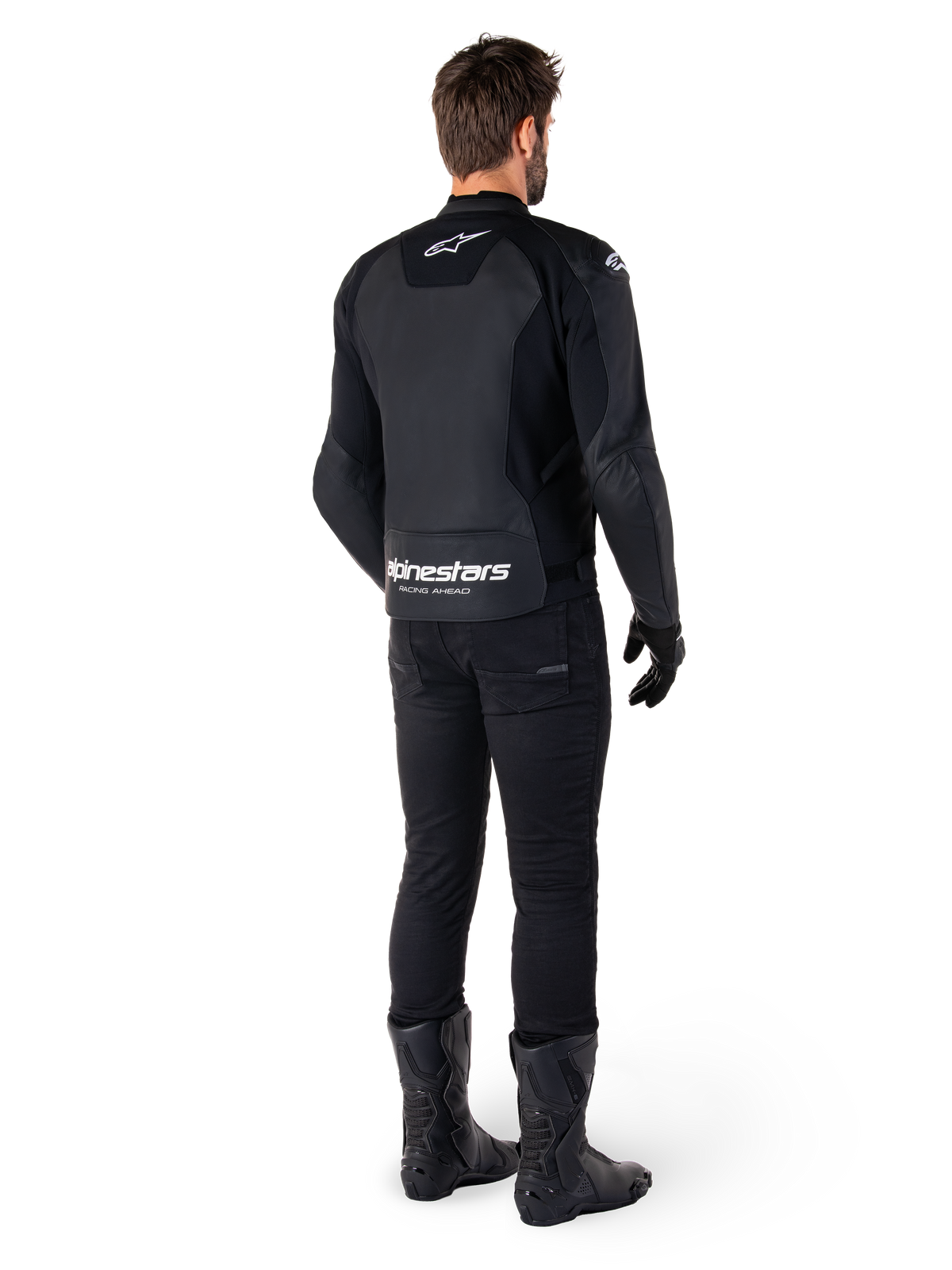 Alpinestars Faster V3 Leather Jacket, Rear View, Black and White, featuring 'alpinestars RACING AHEAD' branding on the lower back, worn with black riding pants and boots, sport-derived leather motorcycle jacket with stretch panels.