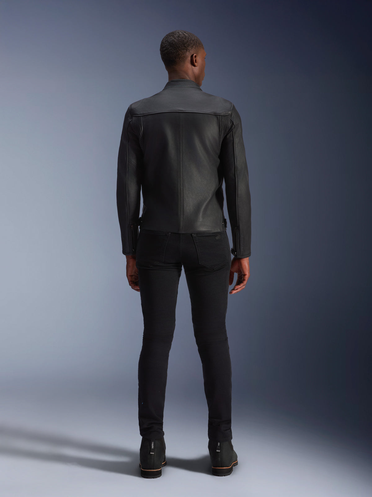 Alpinestars Blacktrack Leather Jacket, men's rear view, black bovine leather with accordion panels for urban riding.