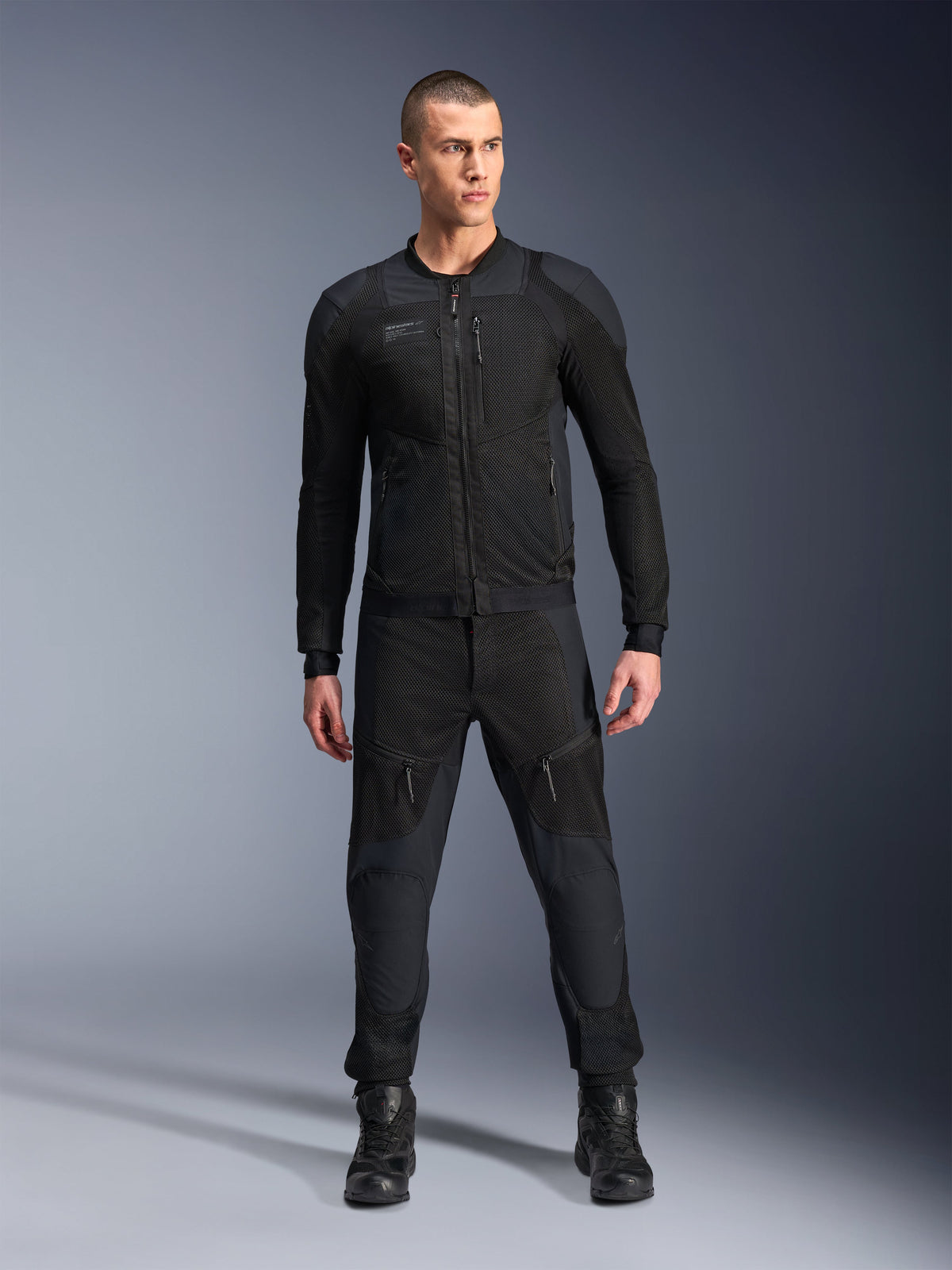 Alpinestars Troop-Air Pro Jacket, Black technical armored motorcycle jacket, featuring mesh panels and front zippers, worn with matching black pants and riding boots, premium urban road gear