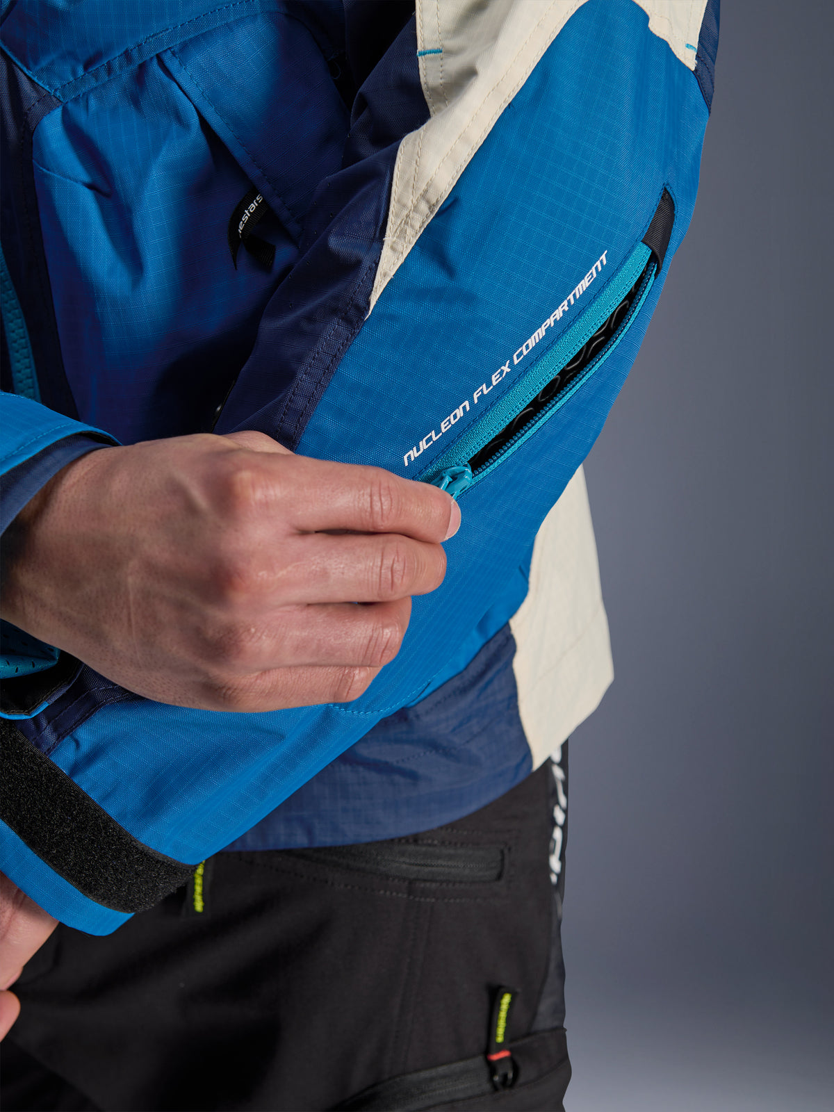 Alpinestars Mogress Air Jacket in Blue and Almond, featuring a zippered Nucleon Flex protector sleeve compartment.
