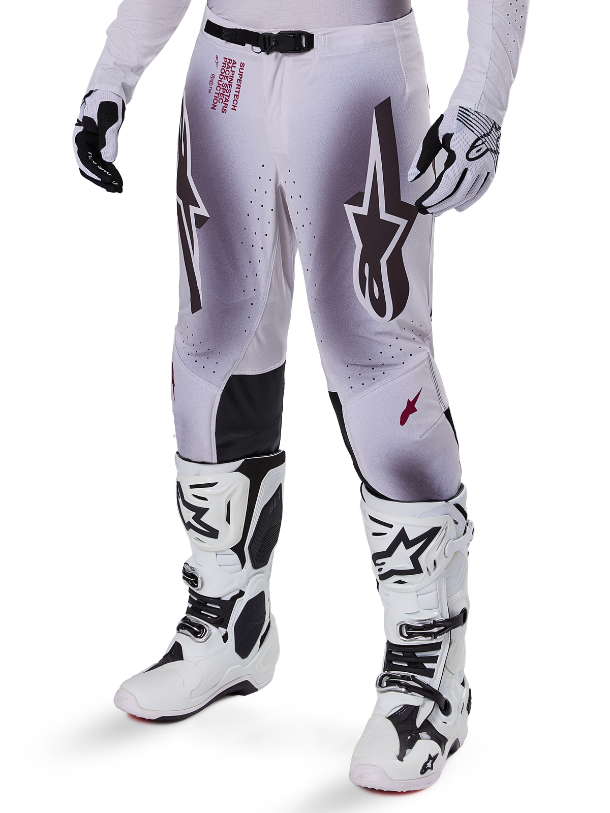 Alpinestars 2025 Supertech Maker Pants, Motocross Racing Pants, Silver and Black, featuring large star logos and red lettering, shown with matching white boots and gloves