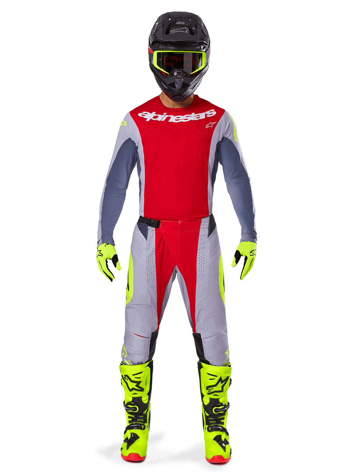 Motocrosser in Alpinestars 2025 Techstar Melt Pants in felrood en grijs, met felrode panelen en fluorescerende gele accenten, gecombineerd met een bijpassende jersey, zwarte helm met fluorescerende gele bril, en felgele laarzen en handschoenen, gecoördineerde outfit voor professionele motocross.