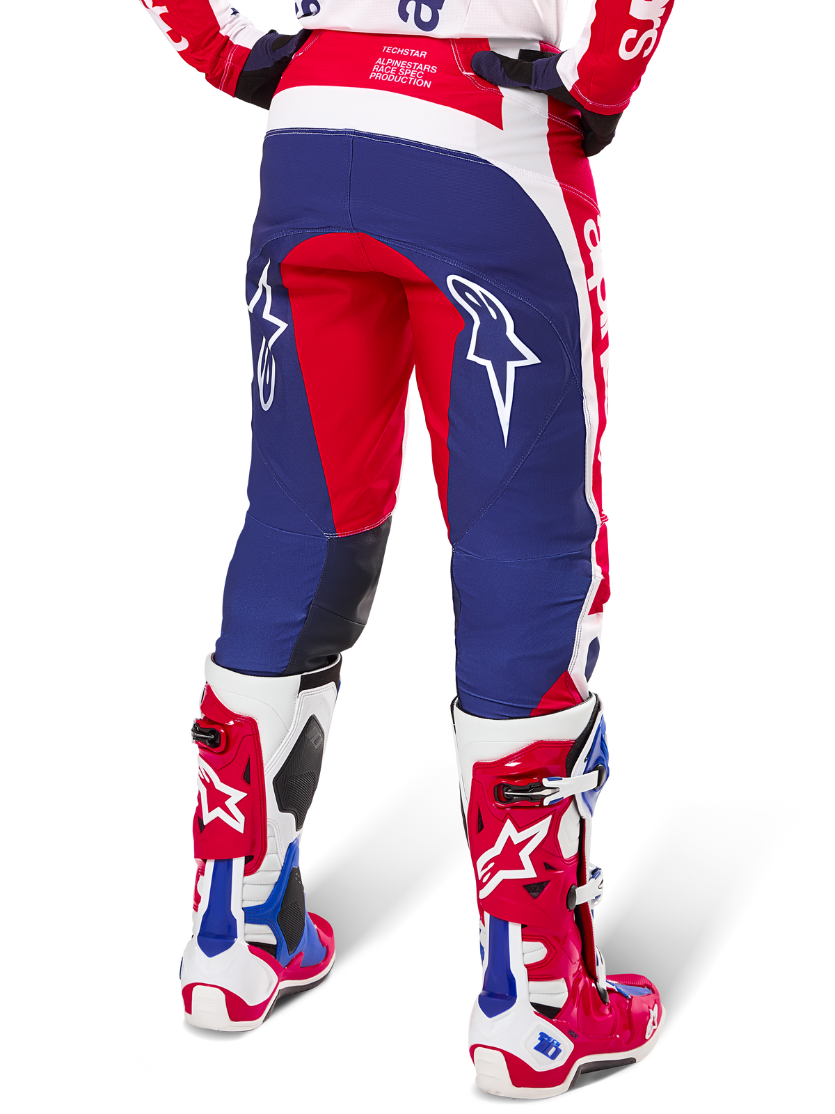 Alpinestars Limited Edition Techstar Fortitude Pants, Motocross Pants, Red White and Blue, back view worn with matching red and white boots, featuring white star logos on the thighs, durable multi-panel design for professional off-road racing.
