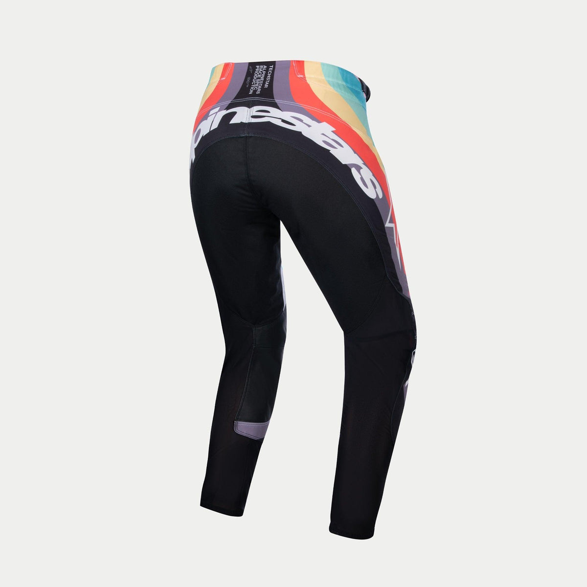 Alpinestars Stella 2024 Techstar damesbroek, motorcrossbroek, zwart multicolor, achteraanzicht met een levendig golfpatroon in rood, oranje en blauw op de taille, groot wit Alpinestars-logo op de achterkant, ontworpen voor off-road racen