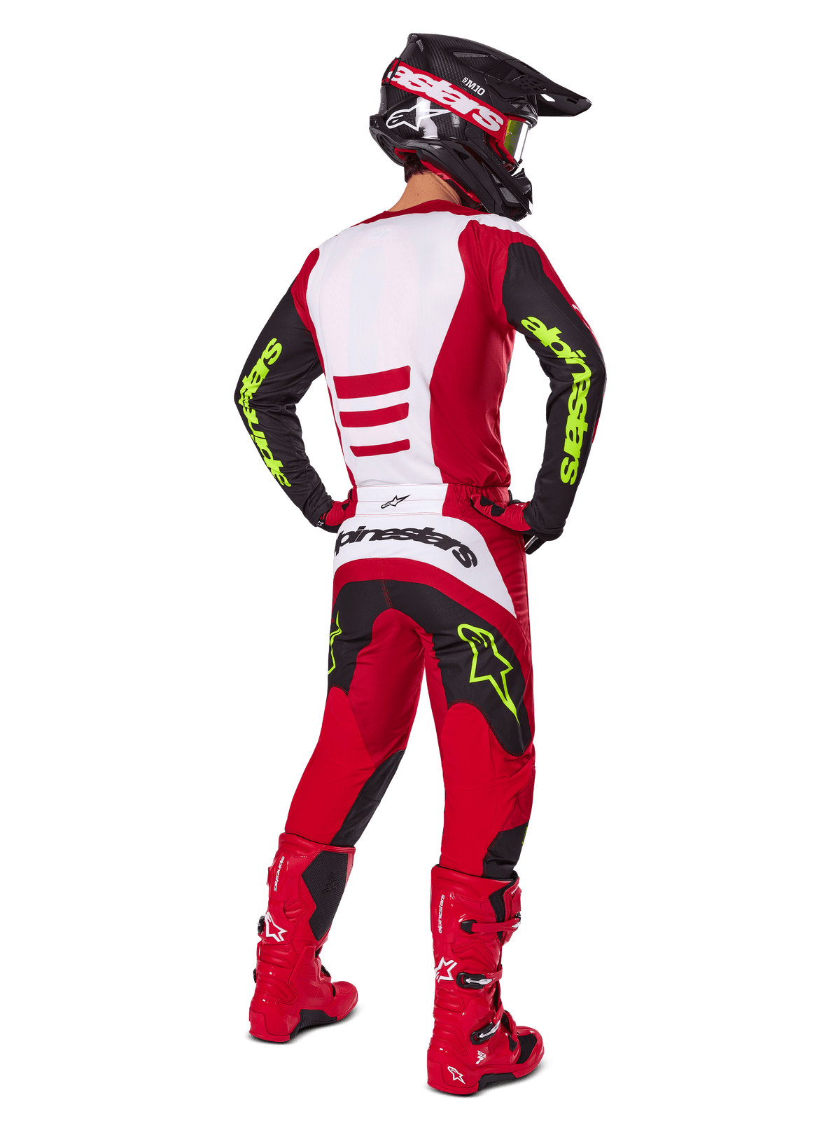 Alpinestars 2025 Fluid Haul Gear Set, motorcrosser van achteren gezien, helderrood en zwart met witte panelen, neongele branding op mouwen en broek, bijpassende rode laarzen en zwarte helm, complete professionele off-road race-uitrusting