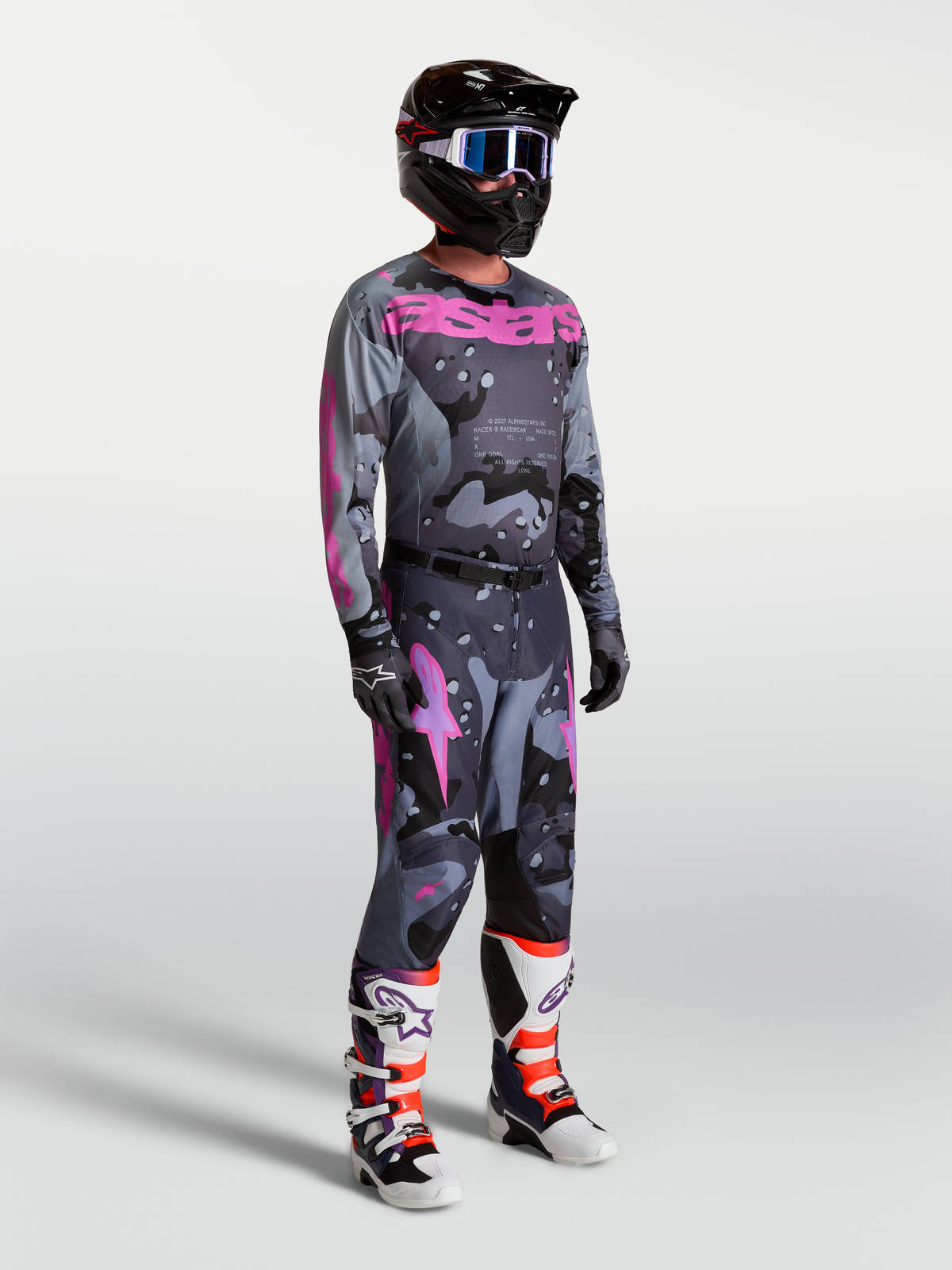 Alpinestars Racer Lone jersey en gear set, heren-motocrosskit in grijs camo en paars, met bijpassende broek en motorlaarzen.