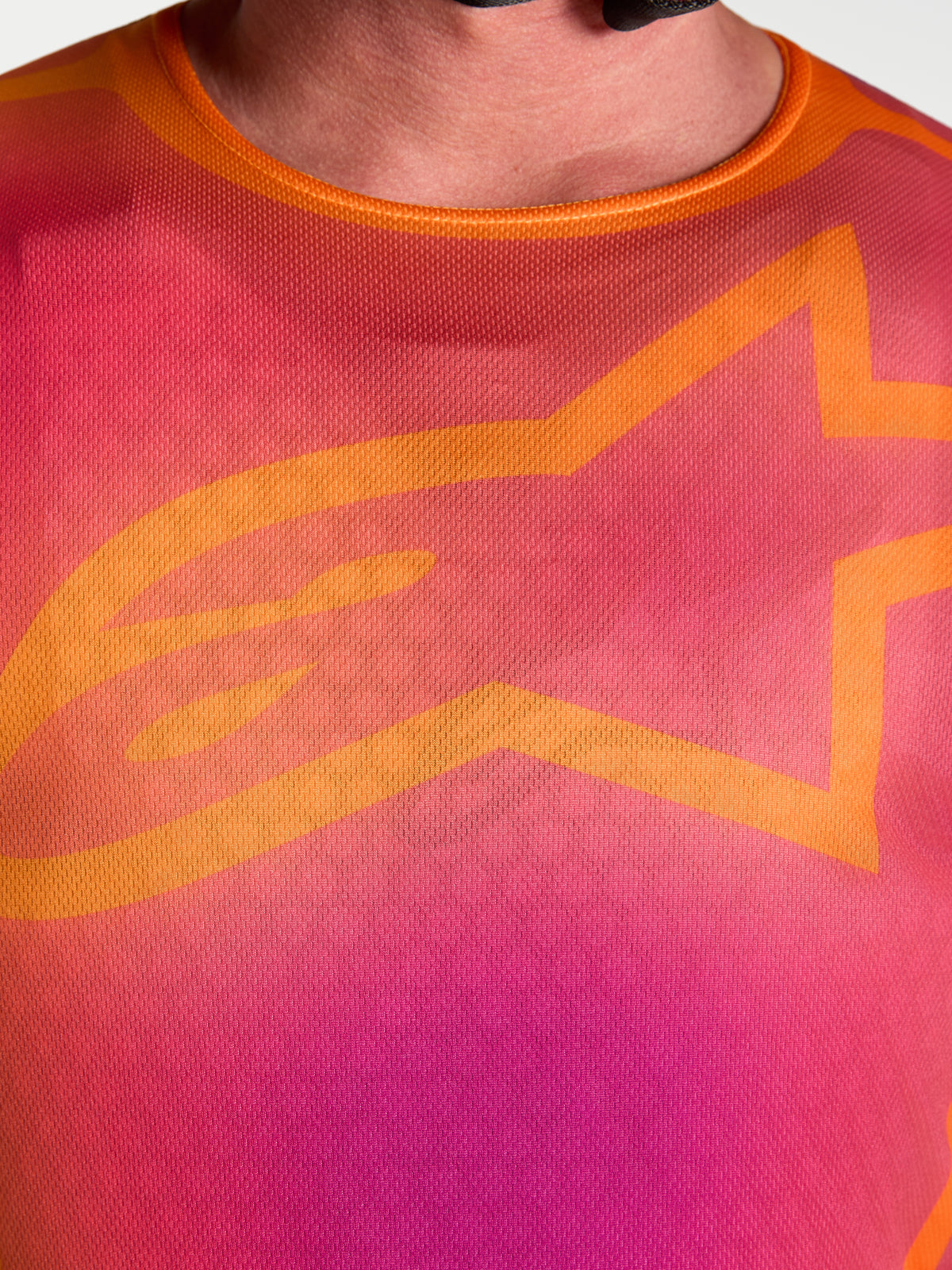 Alpinestars Fluid Kepler jersey, close-up van heren-motocrossjersey, paars en oranje met A-star logo, ademende polyfabric.