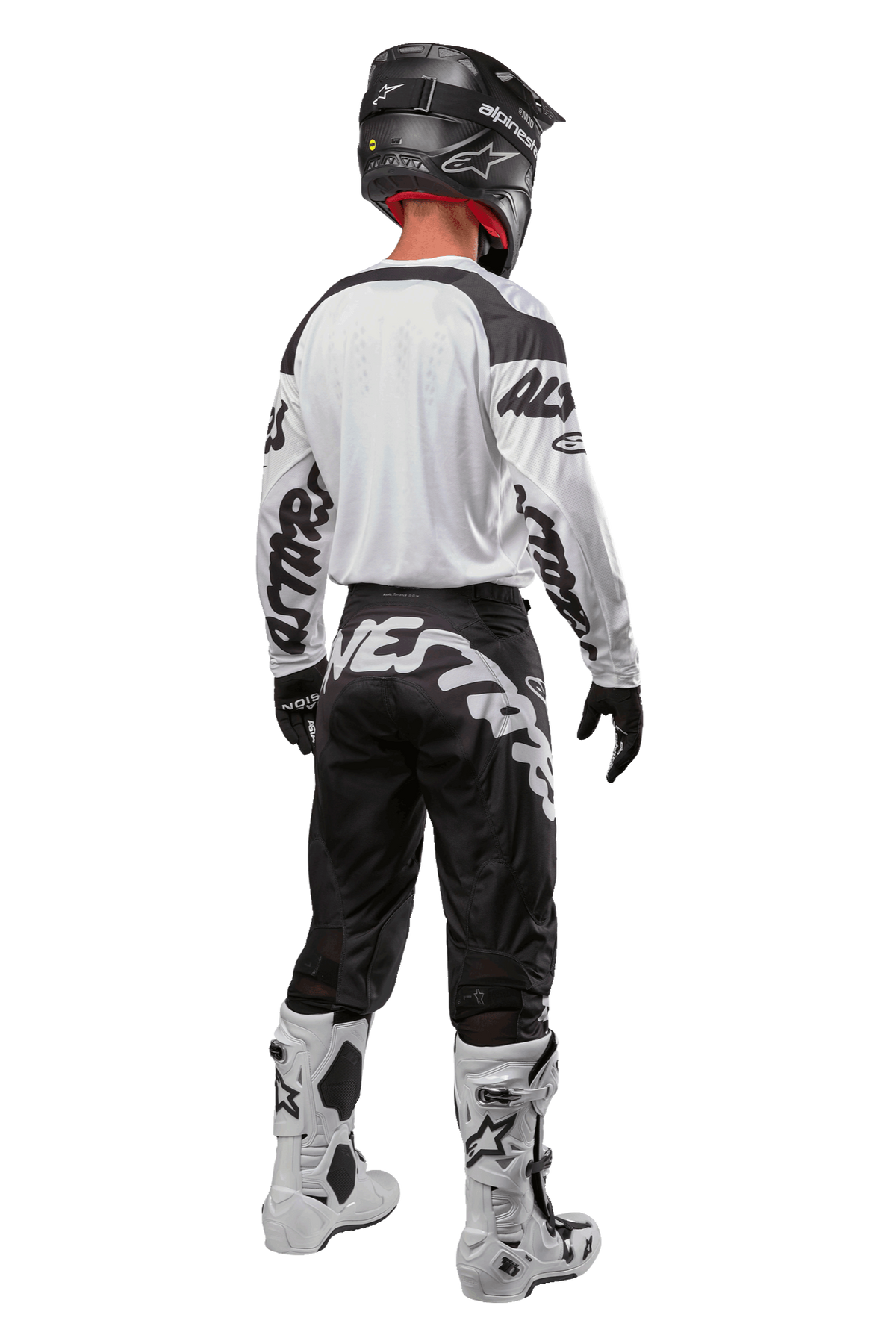 Alpinestars 2024 Racer Hana Jersey, back view of motocross rider, White and Black, white jersey with black graphic branding on sleeves, paired with black pants featuring white Alpinestars lettering on the seat, black helmet, and white and black boots, coordinated off-road racing gear