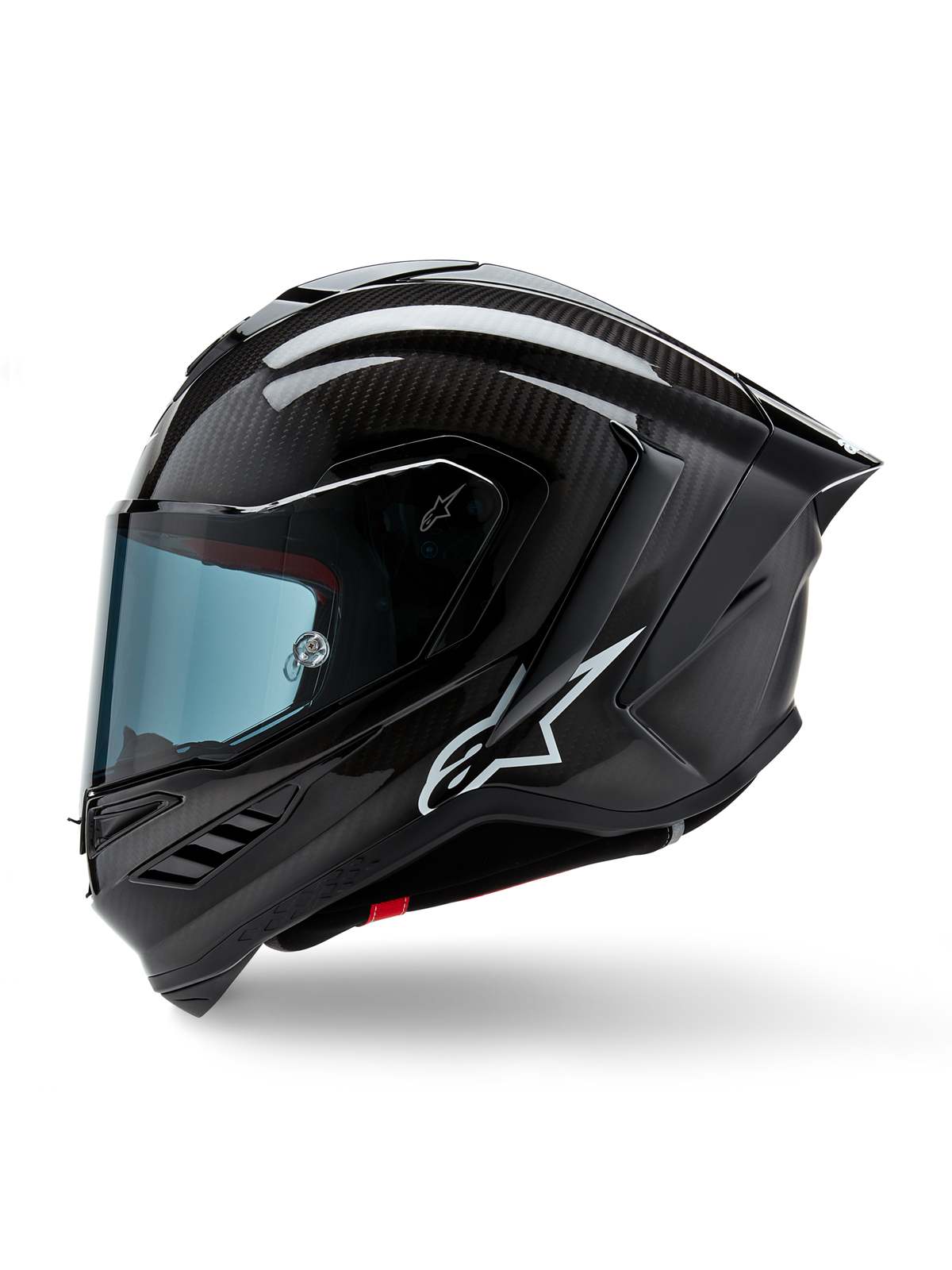 Alpinestars Supertech R10 Solid helm, integraal motorracehelm, zwart carbon mat en glanzend, zichtbaar koolstofvezelweefselpatroon, wit Alpinestars-logo aan de zijkant, aerodynamisch ontwerp met geïntegreerde achterspoiler en ventilatieopeningen, zijaanzicht