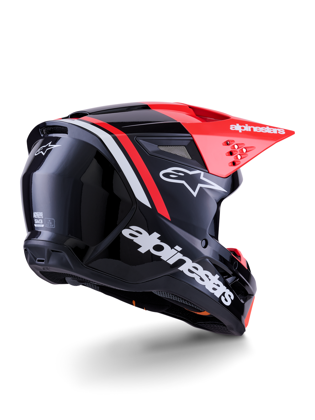 Alpinestars S-M3 Radium helm, motorcrosshelm, glanzend zwart met fluo rood en wit, driekwart achteraanzicht toont het gestroomlijnde aerodynamische ontwerp, witte merklogo's en een felrood vizier, hoogwaardige off-road hoofdbescherming
