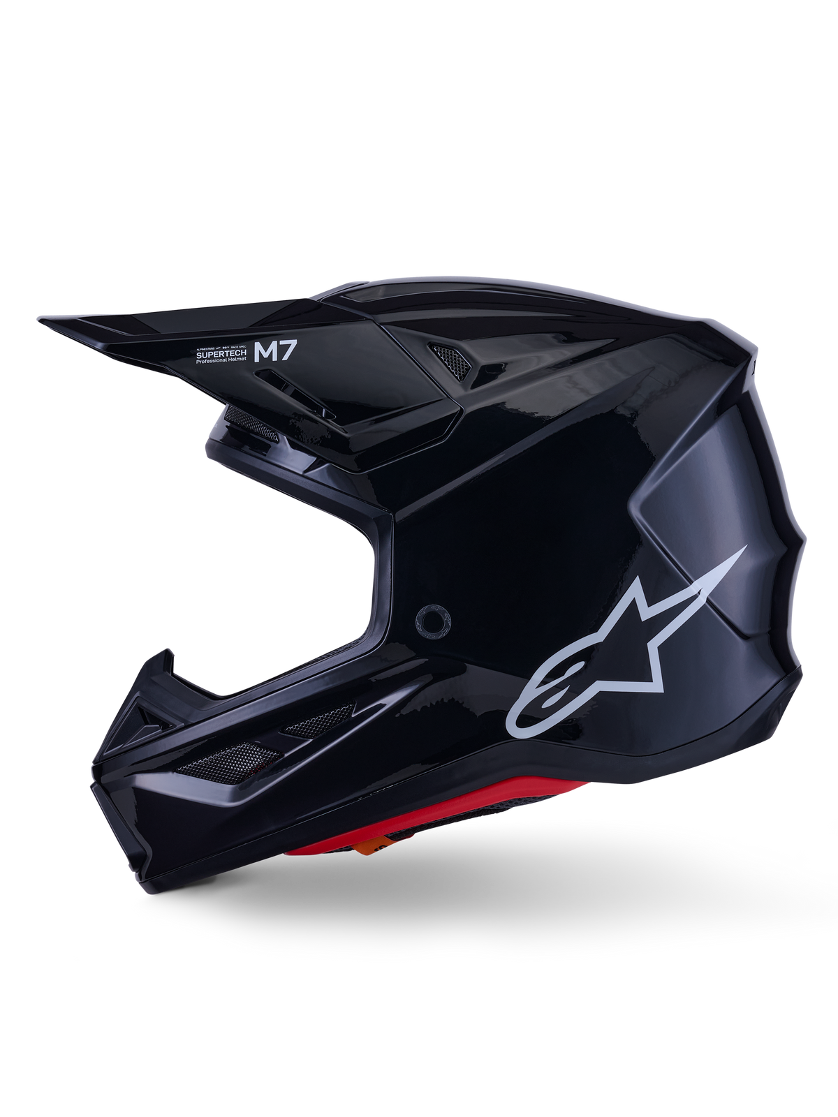 Alpinestars S-M7 Solid helm, glanzend zwarte motorcrosshelm, zijprofiel met wit Alpinestars-logo, aerodynamische schaal met ventilatiegaas en rode binnenvoering, geavanceerde off-road bescherming