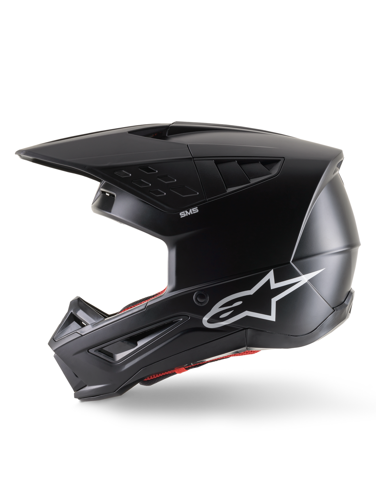 Alpinestars S-M5 Solid helm ECE 22.06, motorcrosshelm, matzwart, zijaanzicht met een strakke matte afwerking, wit Alpinestars-logo op de zijkant, rode binnenvoering en aerodynamische schaal met geïntegreerde ventilatieopeningen