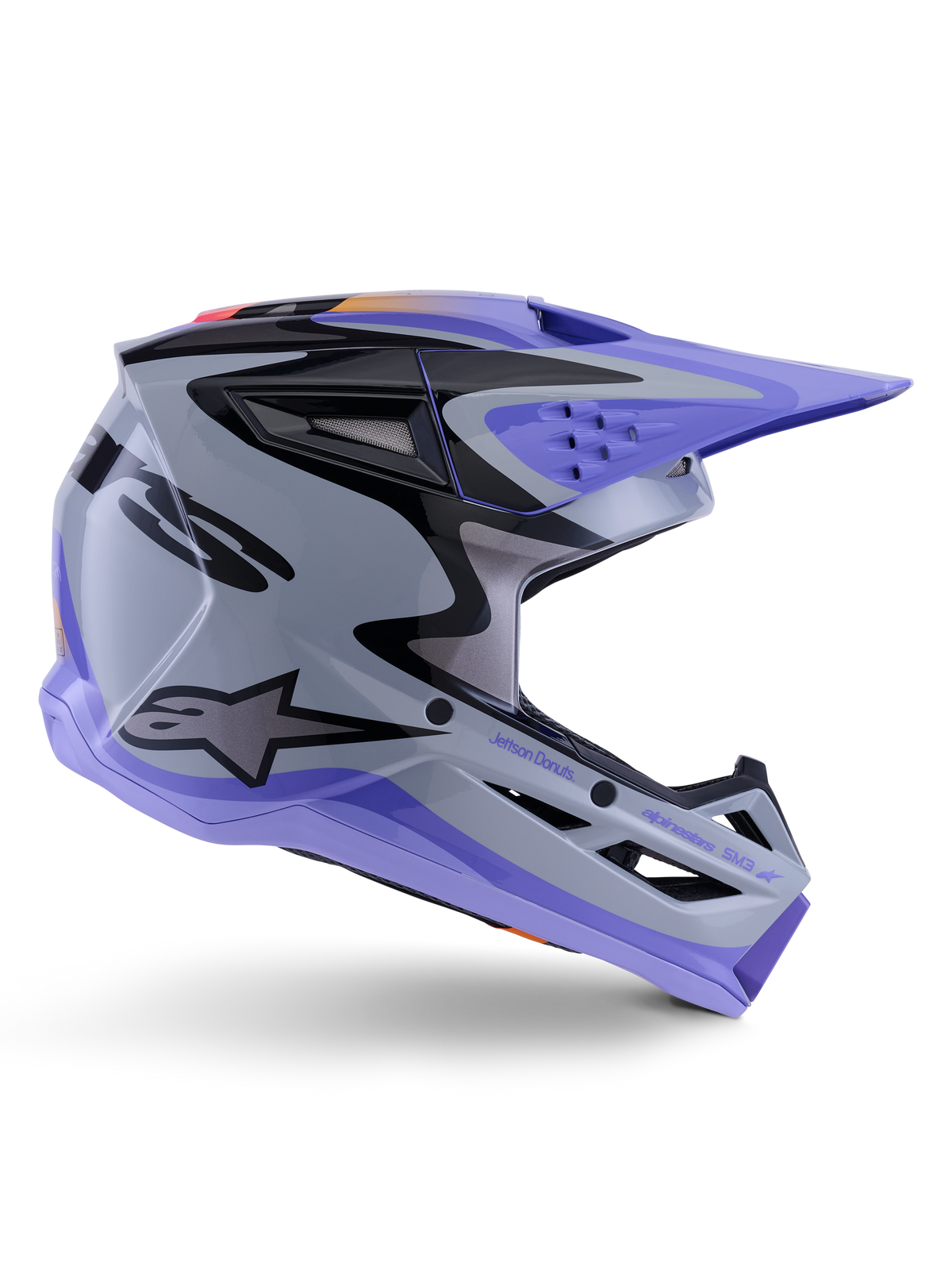 Alpinestars S-M3 Jettson Helm ECE 22.06, motorcrosshelm, grijs, paars en zwart glanzend, zijaanzicht met een paars vizier en kinstuk, slanke aerodynamische schaal met zwarte graphics, meerdere ventilatieopeningen en 'Jettson Donuts' branding aan de zijkant