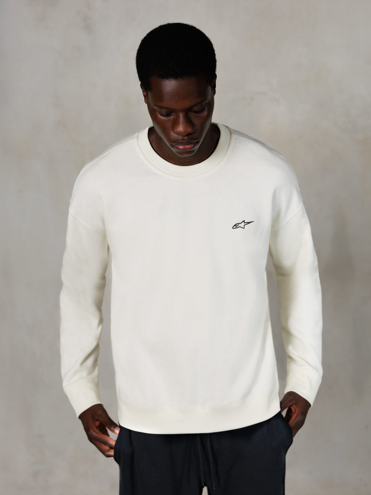 Alpinestars Essentials Ageless Crew, Crewneck Sweatshirt, Off White, small black Alpinestars logo on chest, worn by model, casual lifestyle streetwear, premium soft fleece
