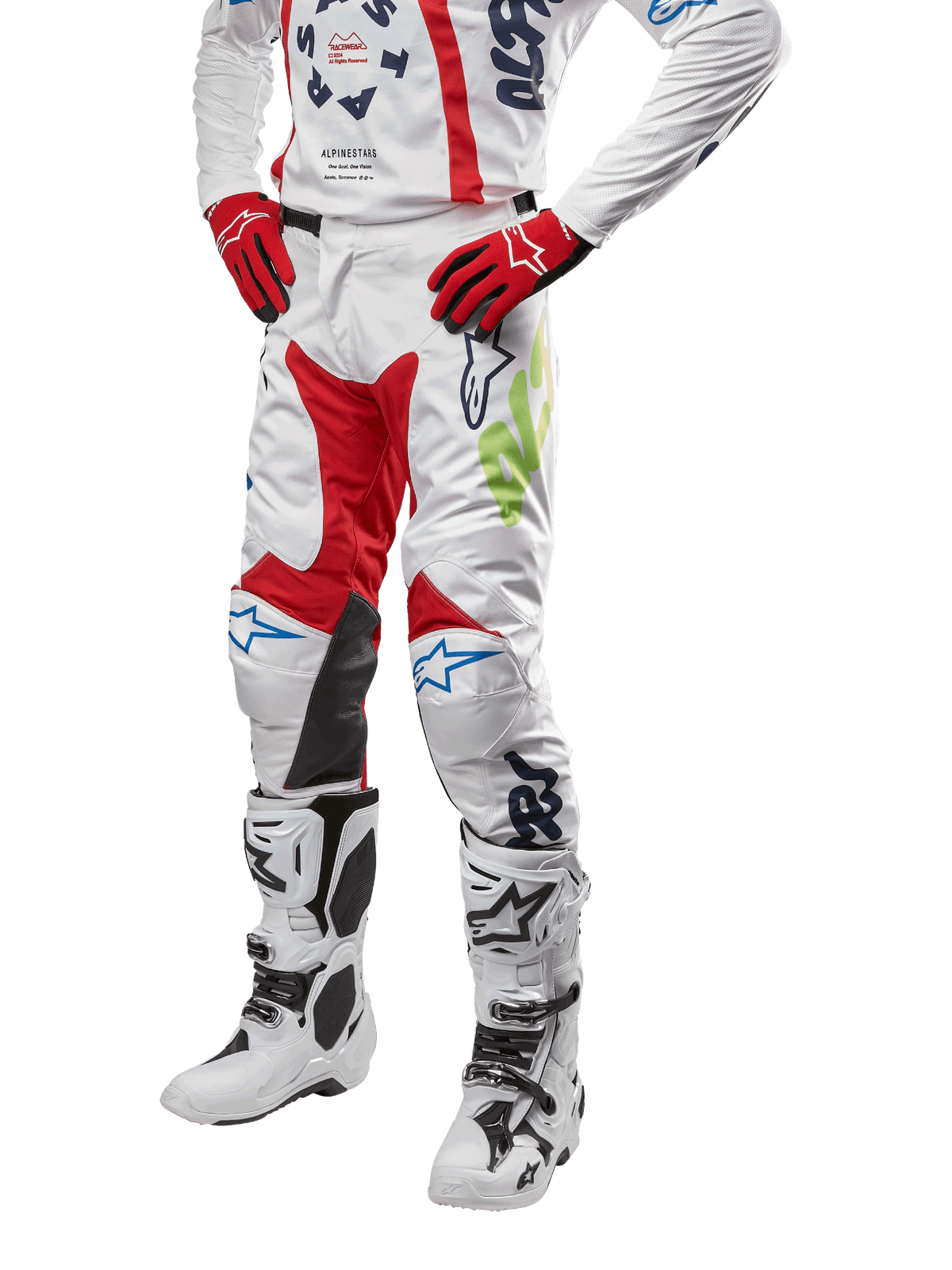Alpinestars 2024 Racer Hana broek, motorcross racebroek, wit met rode, blauwe en limoengroene accenten, beschermend ontwerp met leren kniepanelen, gedragen met bijpassende jersey, rode handschoenen en witte laarzen met gespen, sportieve motorsportoutfit