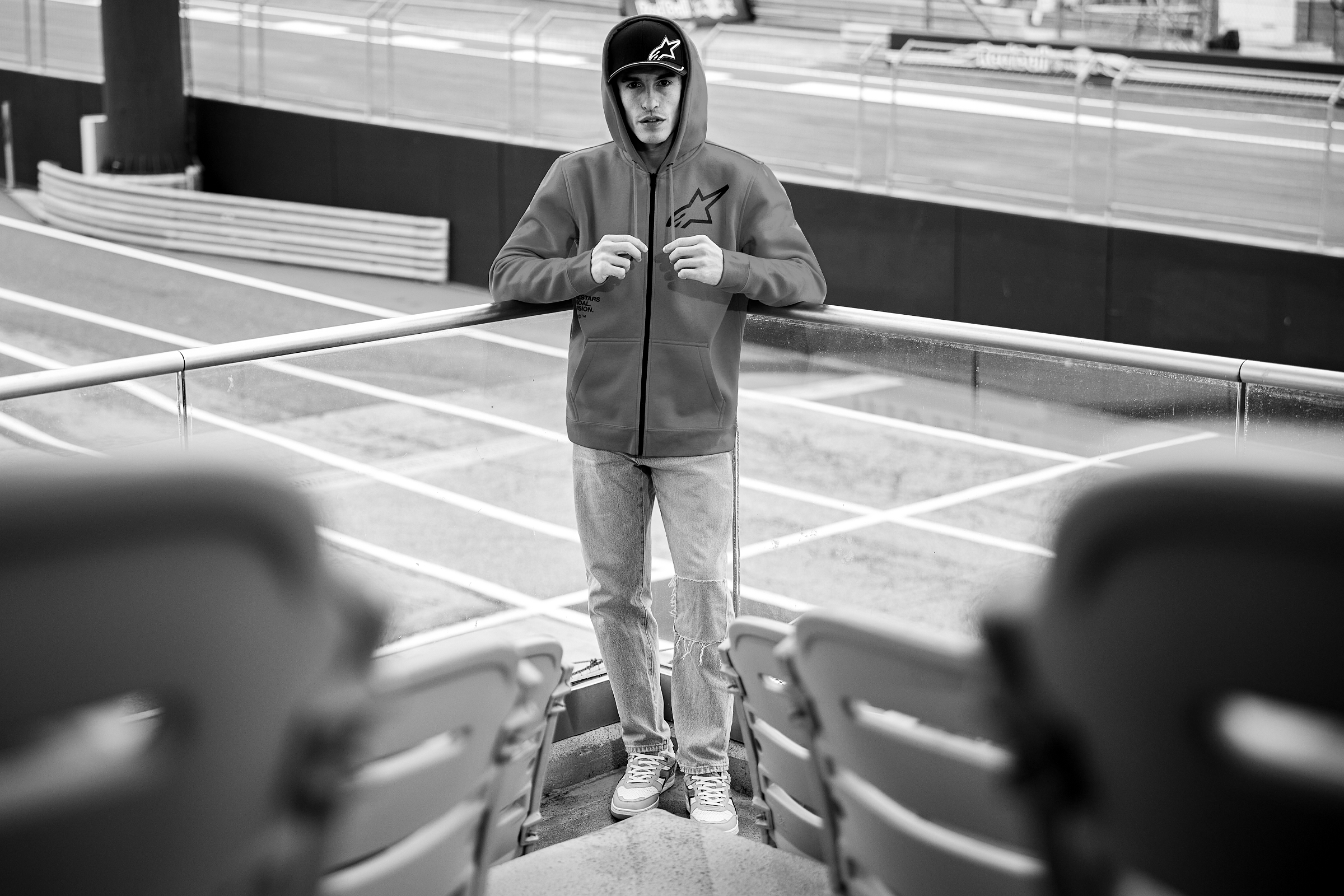 Darkened photo of Marc Marquez wearing an Alpinestars hoodie