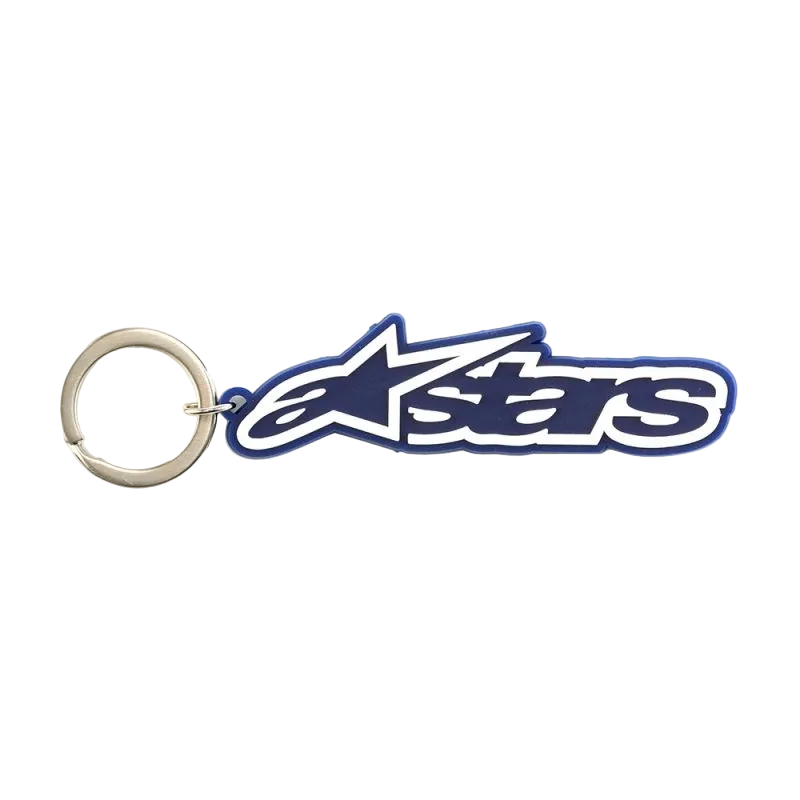 Alpinestars Blaze sleutelhanger, sportswear-accessoire, blauw en wit, 3D rubberen constructie met kenmerkend logo en metalen drukring, motorsport-geïnspireerd race-accessoire.