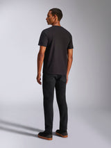 Alpinestars Ageless 2.0 CSF Tee, Short Sleeve T-Shirt, Black, back view on a male model, worn with black pants and gum-soled sneakers, casual motorsport-inspired streetwear