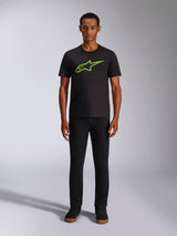 Alpinestars Ageless 2.0 CSF Tee, Short Sleeve T-Shirt, Black with Bright Green Logo, worn by model with black pants, casual motorsport-inspired design