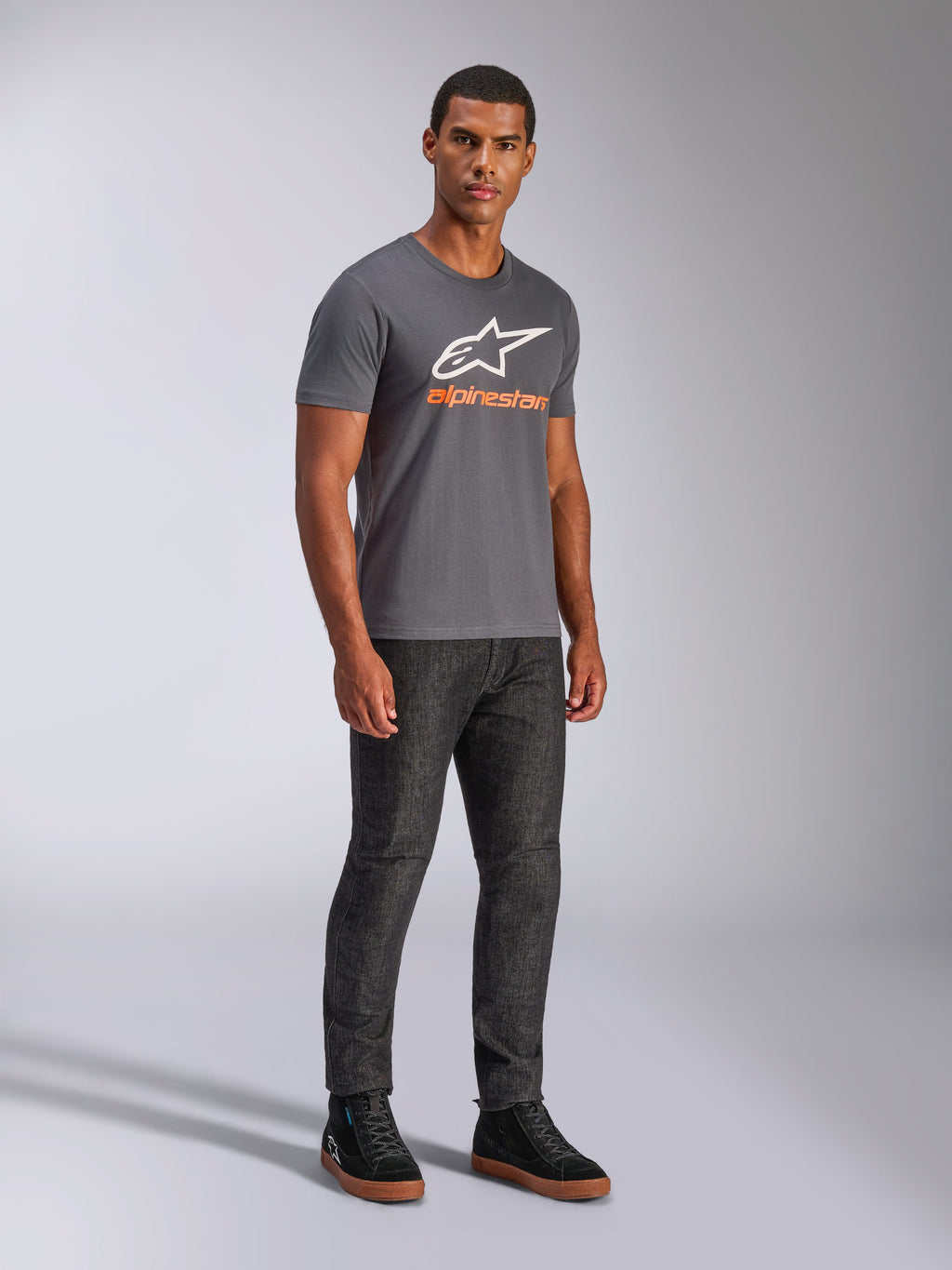 Alpinestars Always 2.0 CSF Tee, T-shirt met korte mouwen, antracietgrijs, wit A-star logo met oranje merknaam, casual motorsport streetwear gedragen met een donkere jeans en zwarte sneakers