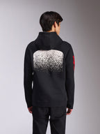 Alpinestars Obsessed Hoodie, achteraanzicht van zwarte pullover fleece hoodie, voorzien van een grote witte gespikkelde MX-verloopgraphic op de rug en rode Alpinestars-woordlogo's op de mouwen, casual streetwear geïnspireerd op de motorsport