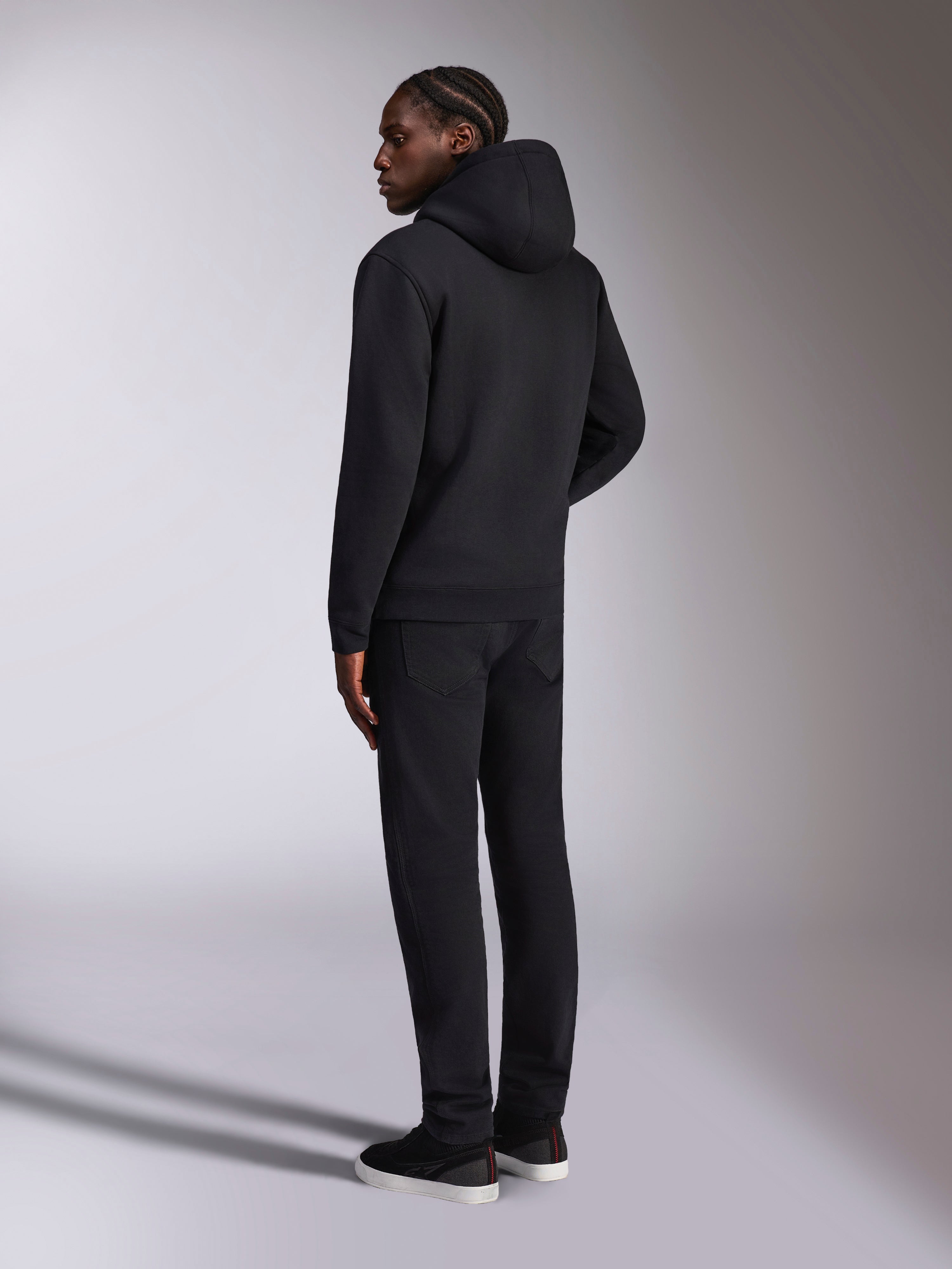 Alpinestars Pulse Hoodie, casual streetwear, Black, back view of model wearing solid black hooded pullover fleece, minimalist design with rib-knit cuffs and hem