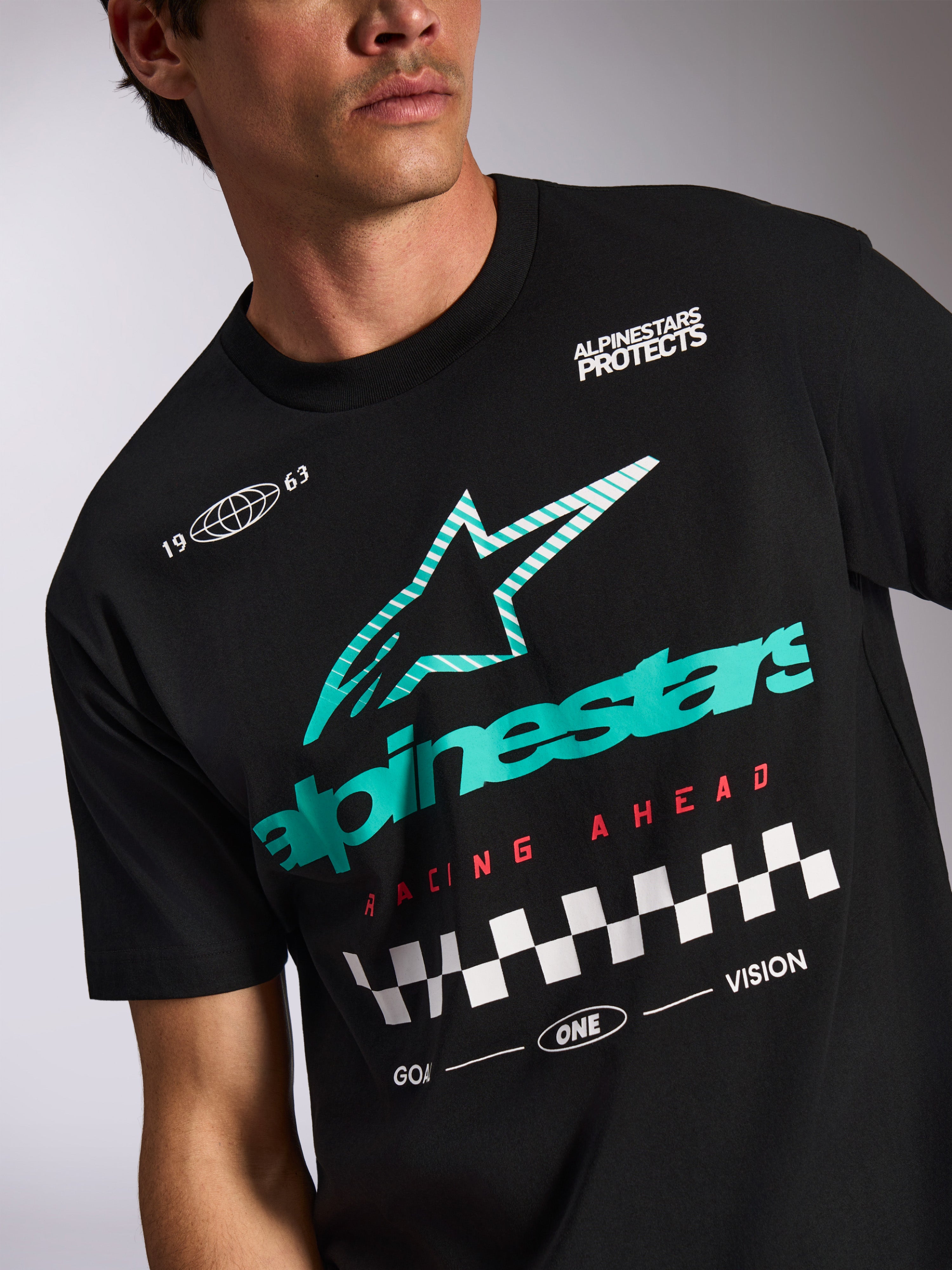 Alpinestars Aplomb Oversized CSF Tee, Short Sleeve T-Shirt, Black, Teal and white striped Astars logo, red 'Racing Ahead' text with checkered flag pattern, casual motorsport streetwear