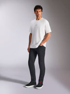 Alpinestars Focused Oversized CSF Tee, Short Sleeve T-Shirt, White, featuring a small black Astars chest logo, worn by male model with dark pants and black sneakers, casual motorsport-inspired streetwear