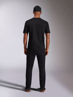 Alpinestars Ellipsoid CSF Tee, Short Sleeve T-Shirt, Black, Back view worn by model with black cap and pants, casual motorsport-inspired streetwear