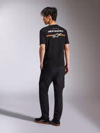 Alpinestars Lanes CSF Tee, Black Short Sleeve T-Shirt, back view featuring white Alpinestars logo with red, orange, and yellow stripe graphics, casual motorsport streetwear worn with black cargo pants