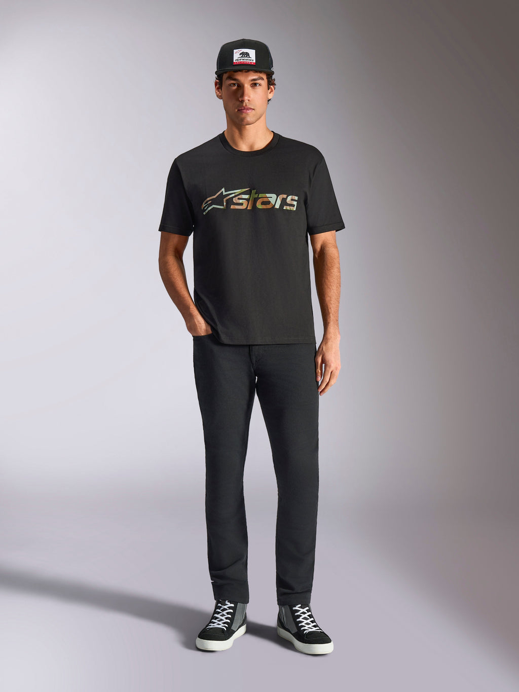 Alpinestars Verdure Camo CSF Tee, Short Sleeve T-Shirt, Black, featuring a camouflage pattern Astars logo on the chest, worn by a model with a black cap and black pants, Casual Motorsport Streetwear