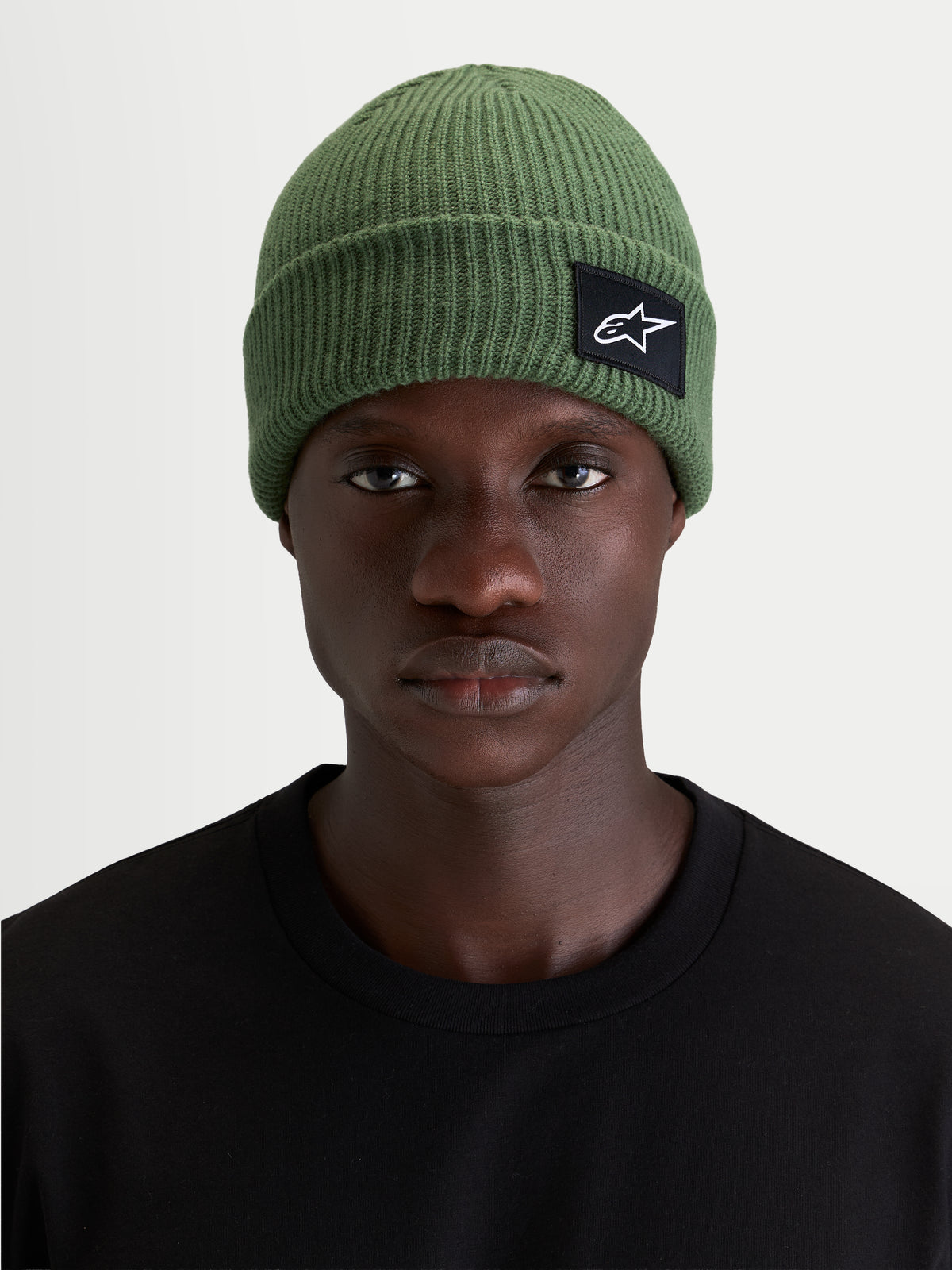 Alpinestars Unload Rib Cuff muts, groene sportswear gebreide muts met ondiepe pasvorm en SAstars geweven patch, gedragen door model