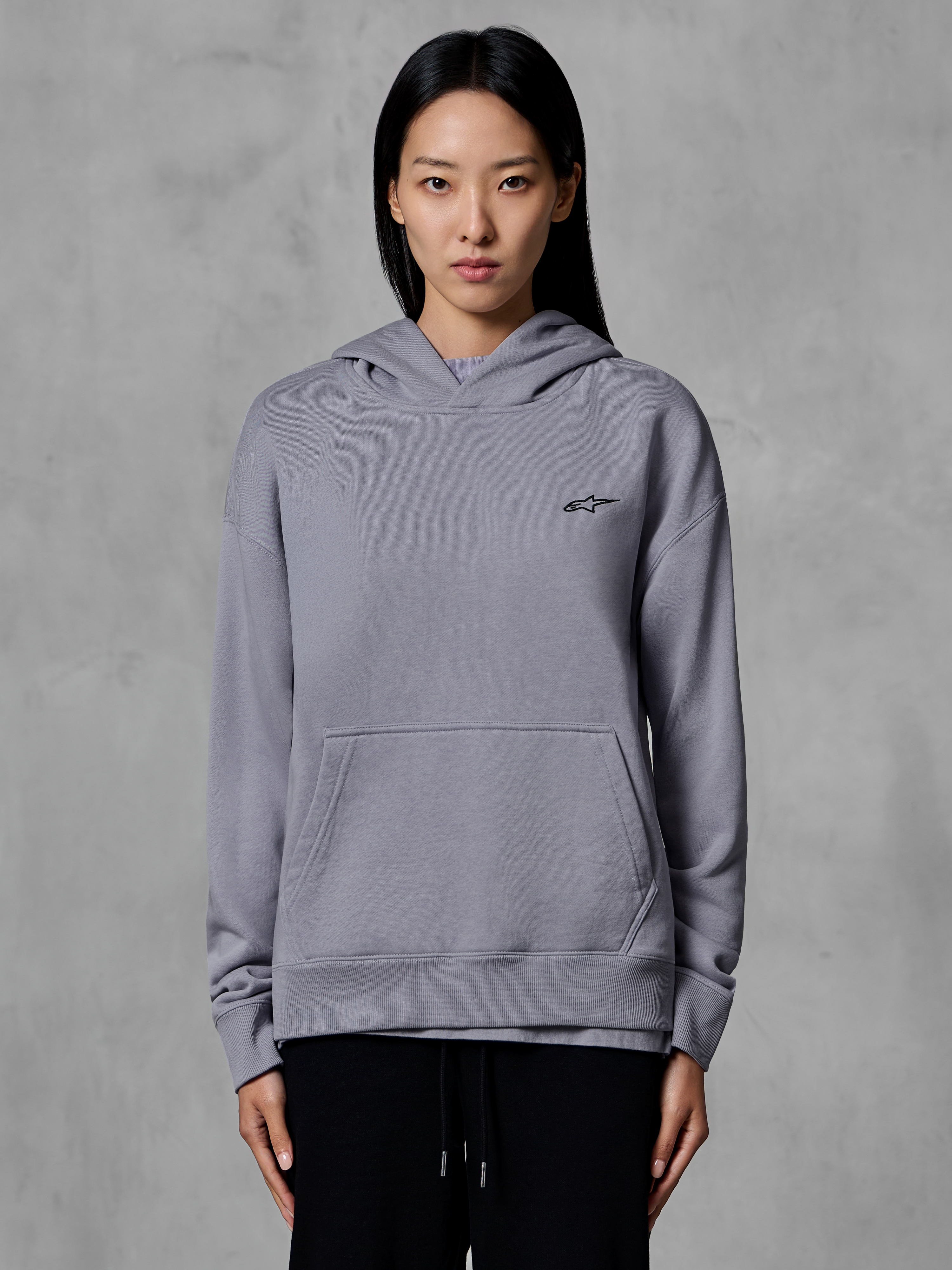 Alpinestars Essentials Ageless Hoodie, casual sportswear, silver with small black logo, kangaroo pocket, hooded pullover, worn by model, modern lifestyle apparel
