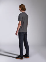 Alpinestars Waving CSF Tee, Short Sleeve T-Shirt, Charcoal, back-side view on model, small black star logo on sleeve, worn with dark denim jeans and black sneakers, casual motorsport streetwear