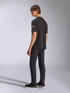 Alpinestars Frontal CSF Tee, Short Sleeve T-Shirt, Black, white astars branding on the sleeve, worn by model with black pants and shoes, casual motorsport-inspired design